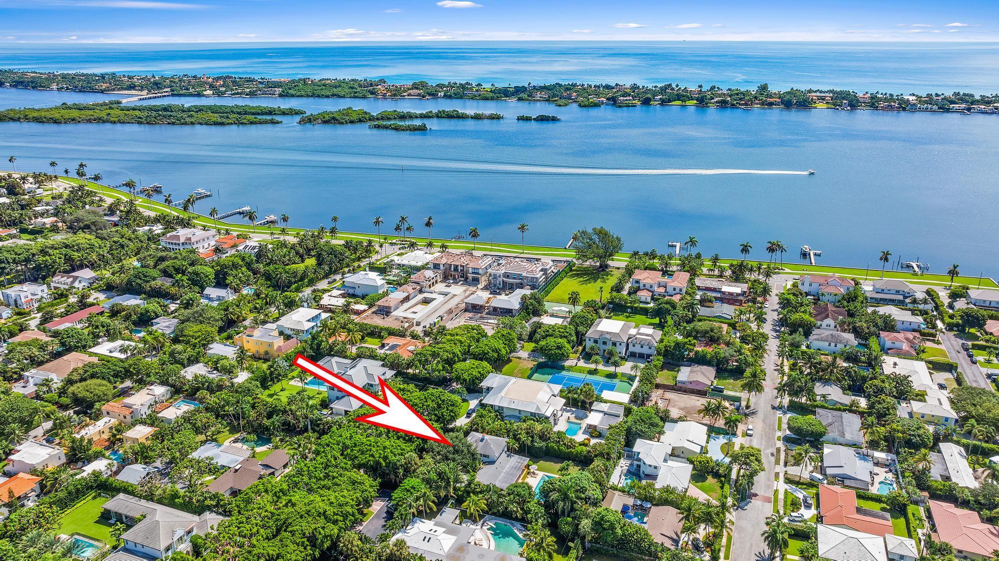 Welcome to 232 Essex Lane! Rare chance to secure a 19,009 sq. ft. lot on one of SoSo's most prestigious streets. Complete with a canopy of banyan trees lining the cul-de-sac, this property offers endless options for those looking to expand or create a custom estate. The current home, a perfect blend of classic Florida elegance & modern updates, includes 4,295 total sq. ft, 4 bedrooms, 5 bathrooms, an office nook & a garage. Unwind in the expansive loggia, offering peaceful views of the lush backyard & swimming pool. The kitchen, featuring quartz countertops & a built-in breakfast nook, effortlessly connects to the outdoor living areas. With a seamless indoor-outdoor flow, this space is perfect for quiet moments or hosting larger gatherings. Additional highlights include impact windows, a sleek powder room, a cozy family room, oak flooring, & recessed lighting. The exterior boasts a charming front entry, leading to a stylish marble foyer. Close proximity to all that Palm Beach has to offer including beaches, Worth Avenue, restaurants, shopping, golf courses, tennis centers, marinas, PBI Airport, Brightline station, great schools, cultural attractions, & more.