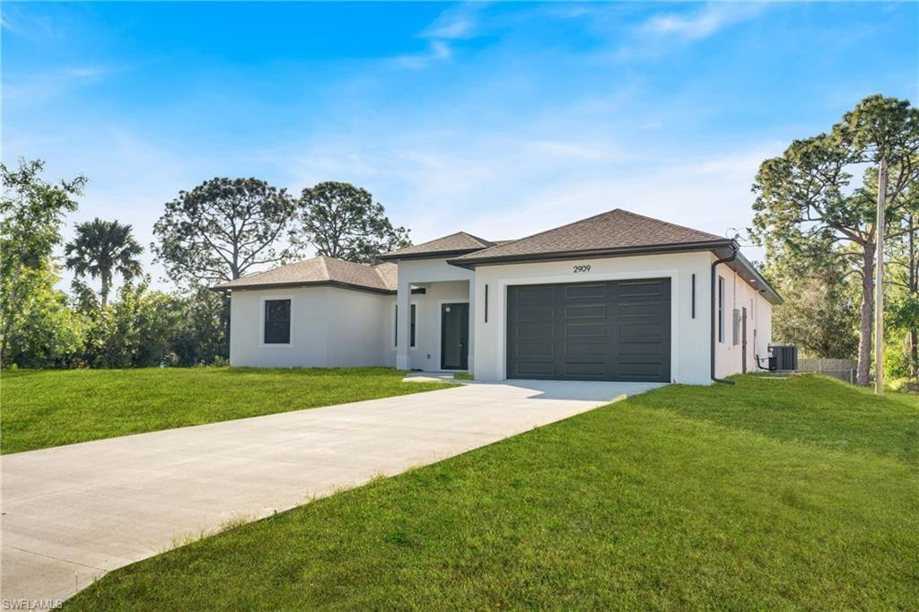 This modern new construction home blends clean architectural lines with a bright, open layout designed for comfort and functionality. Polished tile flooring, recessed lighting, and tray ceilings create a smooth flow throughout the main living areas. The kitchen anchors the space with a waterfall island, modern cabinetry, stainless steel appliances, and designer lighting, making it ideal for hosting or daily living. The primary suite serves as a private retreat with a well-appointed bathroom featuring dual sinks and a tiled walk-in shower. Spacious secondary bedrooms and a large backyard provide flexibility for a variety of lifestyles. Located in a developing Lehigh Acres area with easy access to major roads and local amenities.
