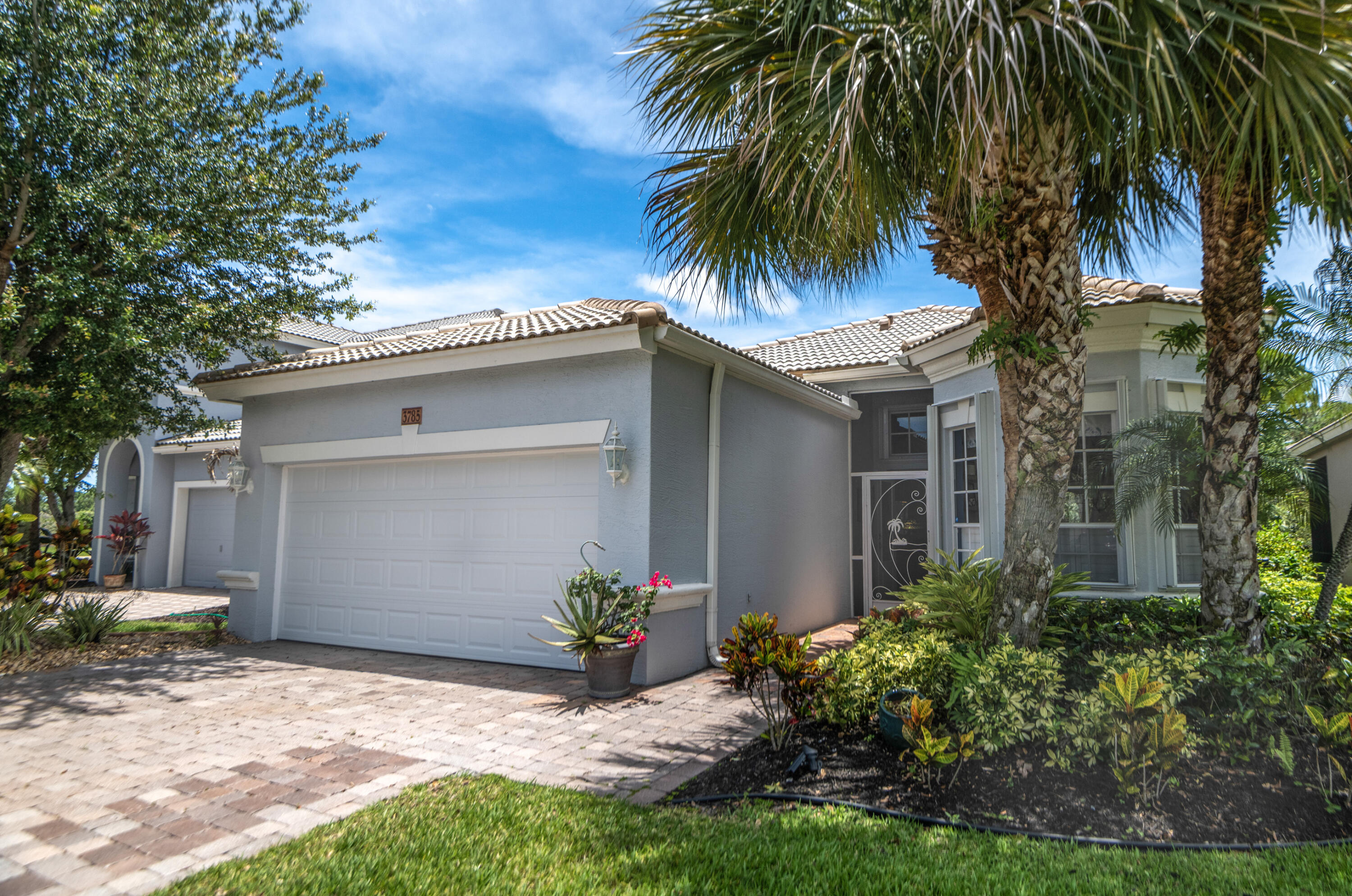 Experience the quintessential Florida lifestyle in this beautifully maintained 3-bedroom, 2-bathroom residence located in the sought-after, gated golf community of Jensen Beach Country Club. Beautiful views backing up to a nature preserve, this home offers the ideal blend of comfort, privacy, and resort-style living. This home features a spacious, open-concept floor plan with 11-foot volume ceilings, crown molding, and a split-bedroom layout. Storm protection with accordion shutters. Amenities provided by the HOA are lawn and landscaping maintenance, lawn irrigation, lawn pest control and fertilization, cable TV and internet, and alarm system monitoring. Jensen Beach Country Club offers a manned gated entrance, community clubhouse, tennis and pickleball courts, and 3 heated pools.