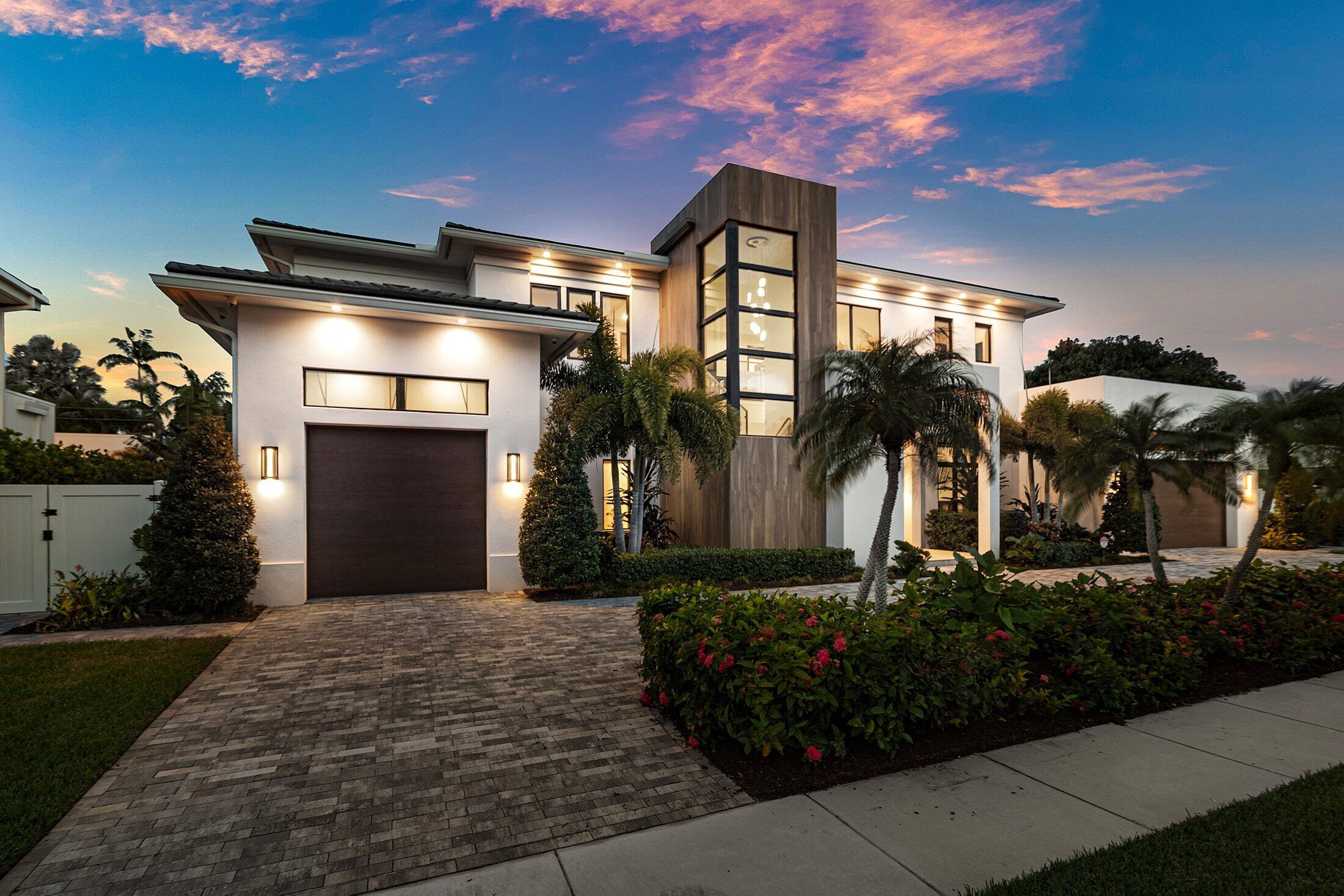 Nestled within the coveted Boca Villas neighborhood of Boca Raton, this exceptional contemporary estate, completed in 2023, showcases a sophisticated blend of striking architecture, bespoke finishes, and modern luxury. Designed for both grand-scale entertaining and effortless everyday living, the residence is further enhanced by a whole-house water filtration system.  Ideally located just moments from Mizner Park, pristine Atlantic beaches, and the renowned amenities of The Boca Raton, the home offers an unparalleled lifestyle in one of South Florida's most desirable enclaves.  Spanning approximately 5,578 square feet, the residence features 5 lavish ensuite bedrooms and six-and-a-half impeccably designed baths, creating an atmosphere of comfort, elegance, and refined privacy throughout. Soaring volume ceilings, a striking glass staircase, private elevator, and expansive walls of impact glass create a dramatic yet welcoming ambiance, bathing the interiors in natural light.    At the heart of the home, the gourmet chef's kitchen is both functional and visually stunning—featuring top-tier appliances, custom cabinetry, and an oversized island designed for effortless entertaining. The open-concept living spaces transition seamlessly to the outdoors, embodying the essence of refined indoor-outdoor living.    The backyard unfolds as a private resort-inspired sanctuary, highlighted by a shimmering pool and spa, a covered loggia, a fully equipped summer kitchen, and lush tropical landscaping—creating an idyllic setting for both grand-scale entertaining and serene everyday living.    Additional features include a spacious three-car garage, generator, advanced smart home integration, and exquisite designer finishes throughout.    Ideally located in one of Boca Raton's most desirable neighborhoods, this remarkable residence offers effortless access to fine dining, luxury boutiques, and the vibrant energy of downtown—presenting a rare opportunity to experience the pinnacle of South Florida luxury living.