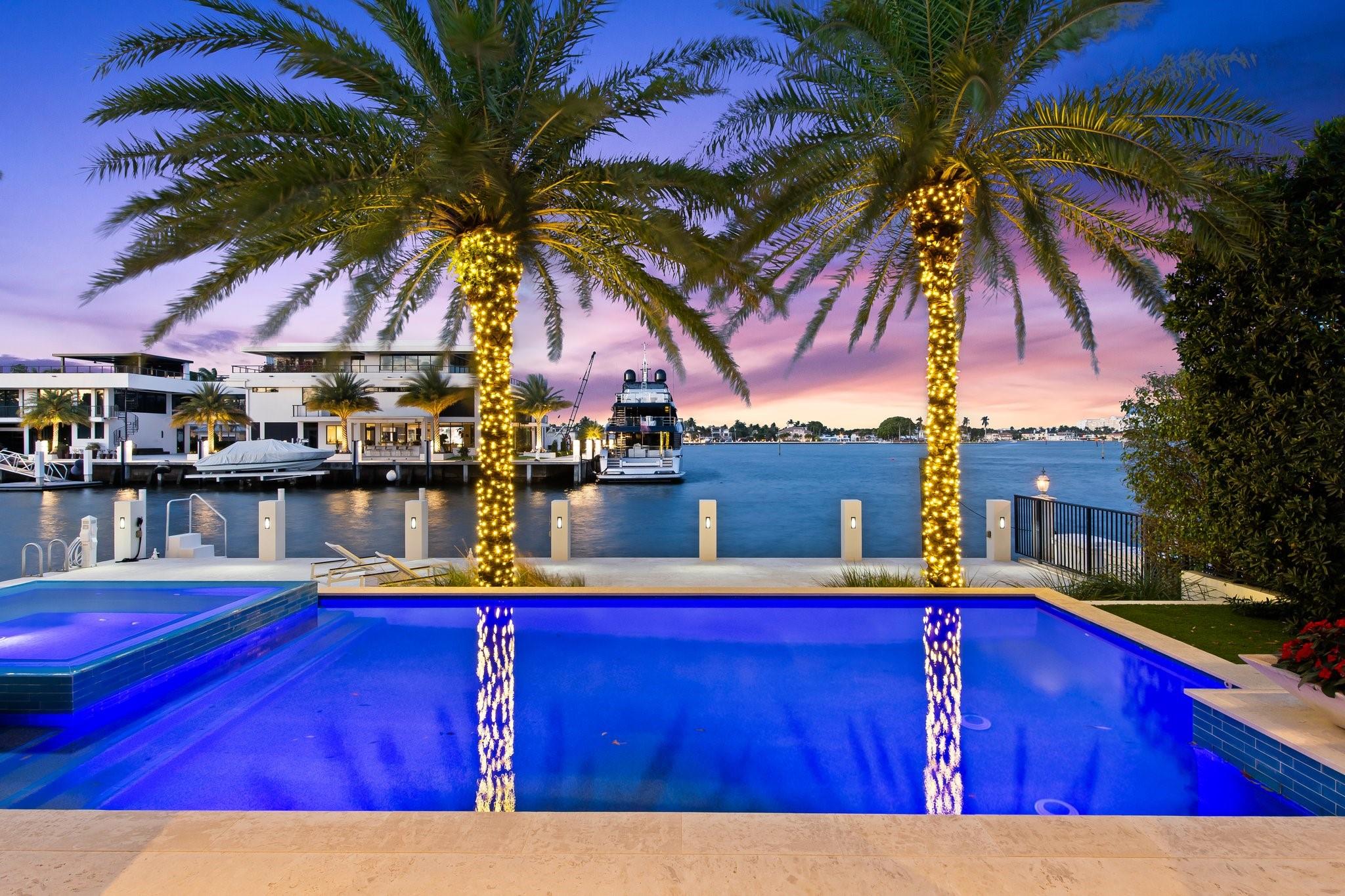 Experience stunning panoramic intracoastal water views from most every room in this home! A brilliant collaboration of architect Bob Tuthill, builder JL Lavallee and interior designer William Peacock this residence features volume ceilings, state of the art gourmet kitchen with Thermador appliances, floor to ceiling windows, huge open balcony overlooking the pool and waterway, gorgeous custom bar for entertaining, 240 square foot walk-in closet in primary bedroom, marble floors, Sonos sound system, laundry room on each floor, triple spilt AC system, 22' deep by 60' wide dock,  tranquil pool and jacuzzi, lush landscaping, golf cart parking space and more!