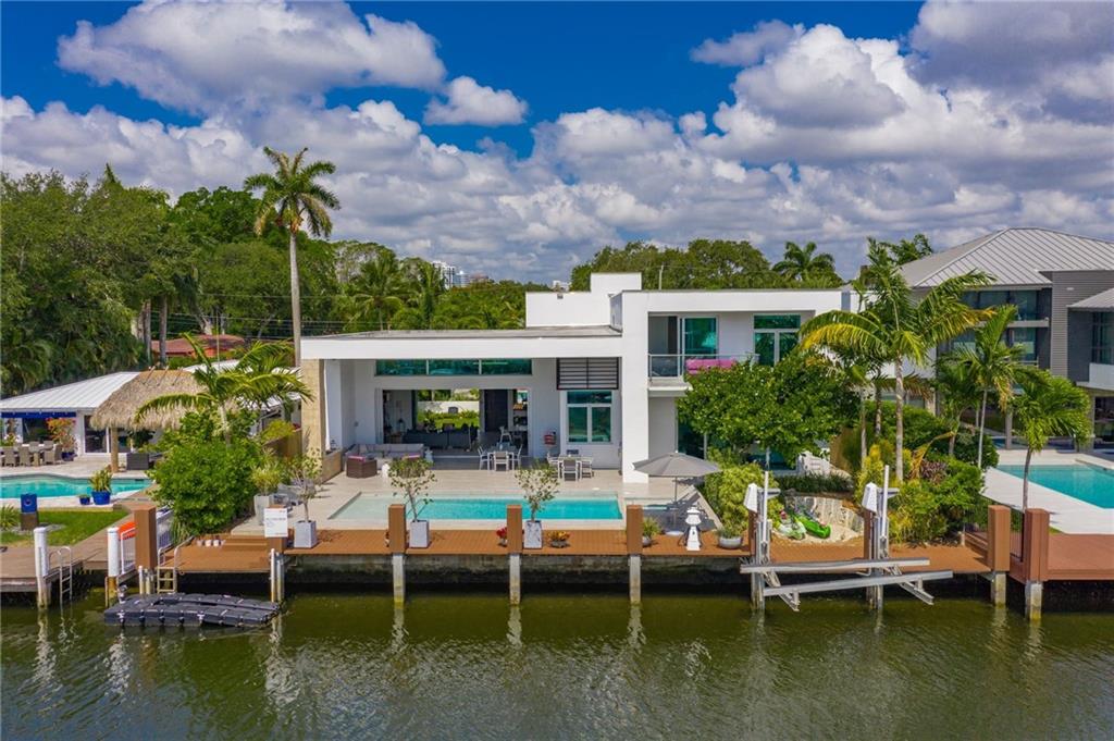 Stunning modern home off Las Olas! Beautiful curb appeal with lush landscaping and warm accents. Interior is set up for entertaining with an open floor plan, breakfast nook, chef's kitchen with high end appliances, light and bright with high ceilings. Top-of-the-line finishes throughout. Large downstairs master suite with walk-in closet and spa bathroom. Pocket doors bring the outside in and invite you to the outdoor living space equipped with water views, pool and spa, summer kitchen and vast covered lounging spaces. Walking distance to Las Olas shopping and restaurants with easy ocean access. Truly a work of art, this home is a must see!