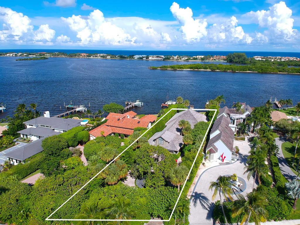 Direct intracoastal South Florida Tropical home with contemporary flare in the exclusive South End neighborhood. There are only 20 properties on direct open intracoastal in the South End. These are premier properties that are NOT in the flight path. Enjoy ocean breezes and intracoastal views from the private back porch of this custom designed home. The family room has 18ft vaulted ceilings overlooking the back porch, pool and expansive views of the intracoastal and Palm Beach. The remainder of the home has 91/2 ft ceilings. Master and two bedrooms are on the first floor and additional room above the garage. All rooms complete with en-suite baths and walk in closets. Brand new full house generator, outdoor grill and beautiful tropical gardens! This is a special waterfront opportunity in an exclusive neighborhood. Walk on the Flagler Lake Trail, minutes to the Palm Beach Inlet, Palm Beach airport, beaches, Worth Avenue, shopping, and fine restaurants. Incredible opportunity to move in now or renovate and make your own!