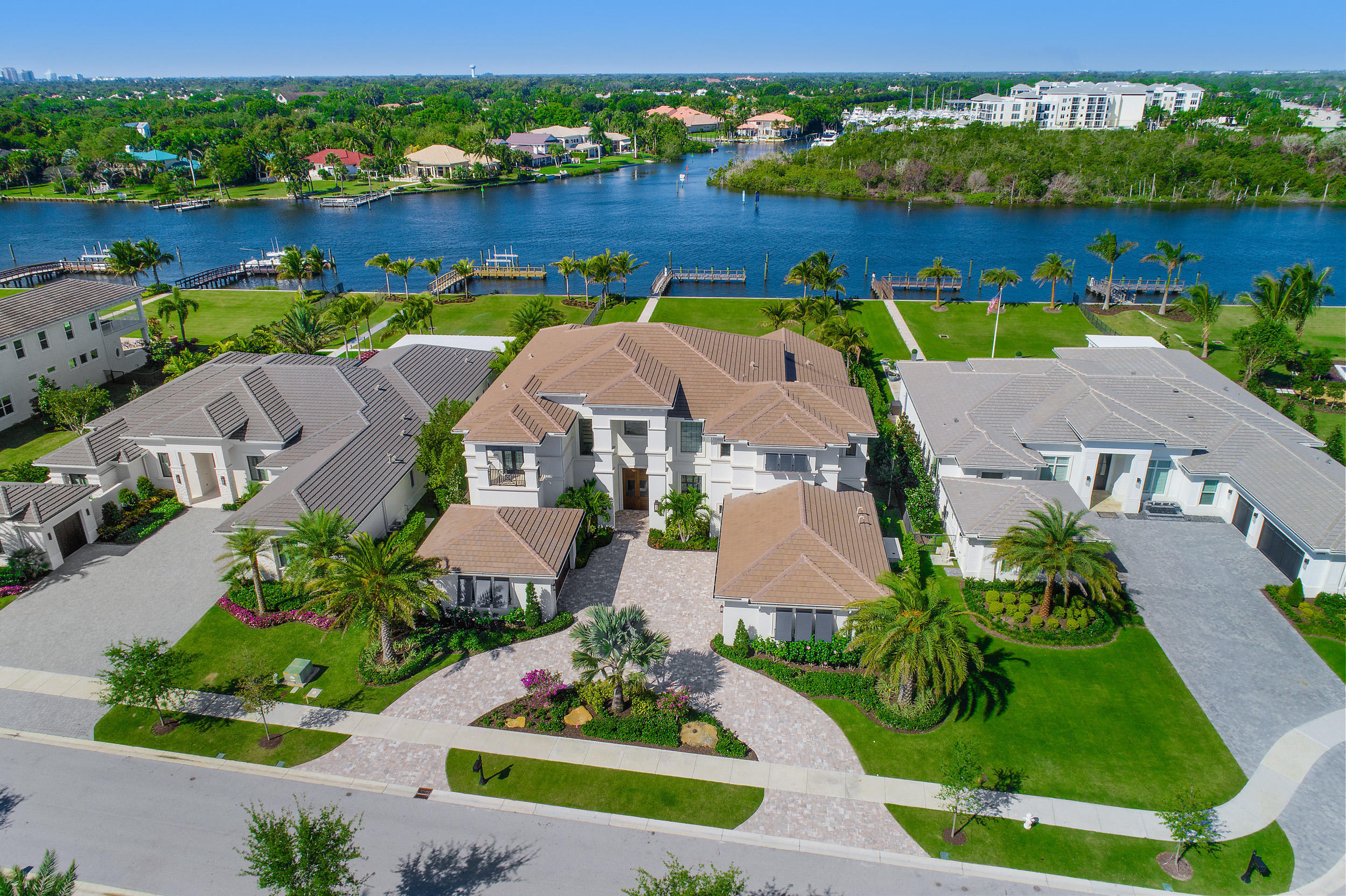 Opulence abounds in this impressive luxury estate home located on 100 feet of direct Intracoastal Waterway in prestigious North Palm Beach. A private 45 foot boat dock has direct intracoastal access with no-fixed bridges and is outfitted with a brand new 26,000 lb lift. The grand, gated entryway leads to a custom-built home with over 1.5 million in upgrades and professionally decorated space by St. Amour Interior Design. Being offered immaculately furnished in the sleek, coastal-contemporary style, you will want for nothing when it comes to elegance or comfort throughout the 10,505 total square feet. This rare offering features 6 bedrooms, 6 full baths, 2 powder rooms, a large office/den and a private elevator. Each floor contains a master suite as well as its own living space and utility room. A private gym with plumbing  can easily be converted to a full 7th bedroom.

Sweeping water views are visible from almost every room and the highest standards of living are met from the moment you enter this well-appointed space. A two-story entryway is flooded with natural light from a wall of windows that encompasses the foyer, formal dining and living space and a full wet-bar for easy entertaining. Flowing beautifully into the adjacent great room, an open-concept kitchen boasts an oversized island with bar seating, two dishwashers, SubZero refrigerator and WOLF 6-top gas range with grilling section. Expertly designed for a seamless transition to outdoor living and entertaining, the living spaces open to an expansive backyard which delivers the ultimate comforts for al fresco dining and relaxing. A large loggia with a full outdoor kitchen, two large screen TV's, and motorized retractable screens allow for enjoyment year-round. Cool off in the beach-entry pool with built-in loungers or perfect your putt on the customized green just steps from your backdoor. A ground-floor master is an elaborate suite with floor-to-ceiling windows and water views, direct access to the backyard, high coffered ceilings, walk-in closets with custom built-ins and its own garden view office. The regal master bath has a spa bathtub, a walk-in shower with electric controls, two separate vanities and separate W.C. Take the private elevator or climb the open, hardwood staircase to the second level which lives like a house all of its own. A loft-style living space with a kitchenette is available for the 5 upstairs bedrooms and there is an additional full-size utility room for upmost convenience. The home is complete CBS construction top to bottom with hurricane-impact windows, all outfitted with electric blinds, black out shades and exterior plantation shutters. Located in Frenchman's Harbor, an exclusive Toll Brother's community with just 78 waterfront residences and 24-hour manned security, perfectly situated near Florida's most pristine beaches, finest shopping and dining, boating, golfing and more.