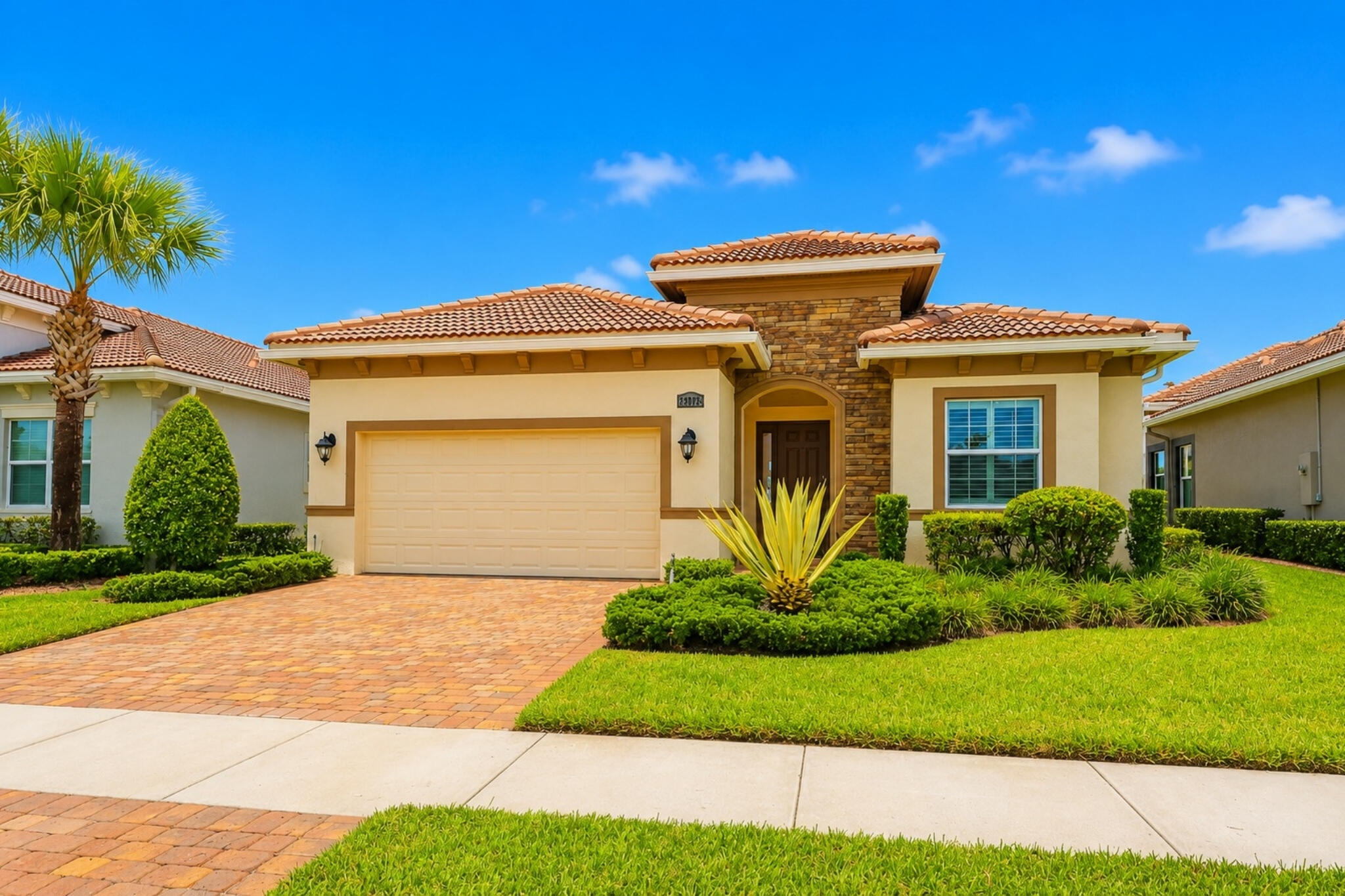 Welcome to both a home and community with endless luxury amenities. This 2200+ square foot home is equipped with impact windows and doors, a tile roof, plank tile flooring, and plantation shutters throughout. Step inside and you'll love the open layout and loads of natural light pouring through the backyard windows. The kitchen offers a huge quartz island, matching GE stainless steel appliances, a tasteful tile backsplash, pantry, in-wall oven, crown-topped cabinets, and large convenient farm sink. The kitchen extends into both a dining room and family room overlooking the gorgeous waterfront views from your backyard. Walk into the master suite and you'll love the coffered ceiling and continuous waterfront views. The master bathroom boasts a dual quartz vanity, 24" tile flooring, and a walk-in closet big enough to be confused for another bedroom (wait until you see it!). The second bedroom offers a second suite with its own bathroom, along with your own private shower. An additional den can act as a second family room, or an office, and comes with beautiful french doors. The laundry room has a matching LG washer/dryer set, laundry tub, 4 storgae cabinets, and a storage closet. Open the family room slider to your backyard haven and you'll enjoy your favorite beverage from your screened patio with paver flooring while taking in the stunning sunrise and sunset views each and every day. And if you're feeling adventurous, hop in your golf cart and head on up to the clubhouse to enjoy the heated junior olympic sized pool and spa, heated outdoor resort pool and spa, fitness center, aerobics room, mens and womens locker rooms, massage rooms, sauna, tennis courts, bocce courts, and basketball courts. If you're looking for the ultimate in resort living, this is it.