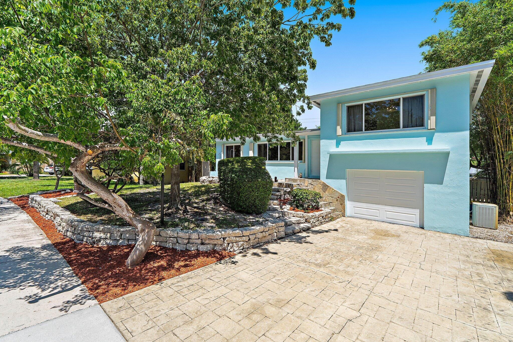 Welcome to this charming pool home nestled in the heart of Lake Osborne! This single-family residence offers a 3 bedroom split floor plan, 2 full bathrooms, completed with an oversized basement featuring a spiral staircase and built-in bar offering extra flex space for entertaining, home gym, or additional living area. Step outside to your own private tropical oasis, with a screened-in back patio overlooking your fully fenced backyard, oversized swimming pool, lush mature landscaping and tiki bar- ideal for enjoying the South Florida lifestyle year-round. Located just one block from the beautiful Lake Osborne, you'll have easy access to scenic walking and biking trails, boating, fishing, and waterfront parks. Conveniently situated just minutes from pristine beaches, fine dining, shopping, and highway access.
