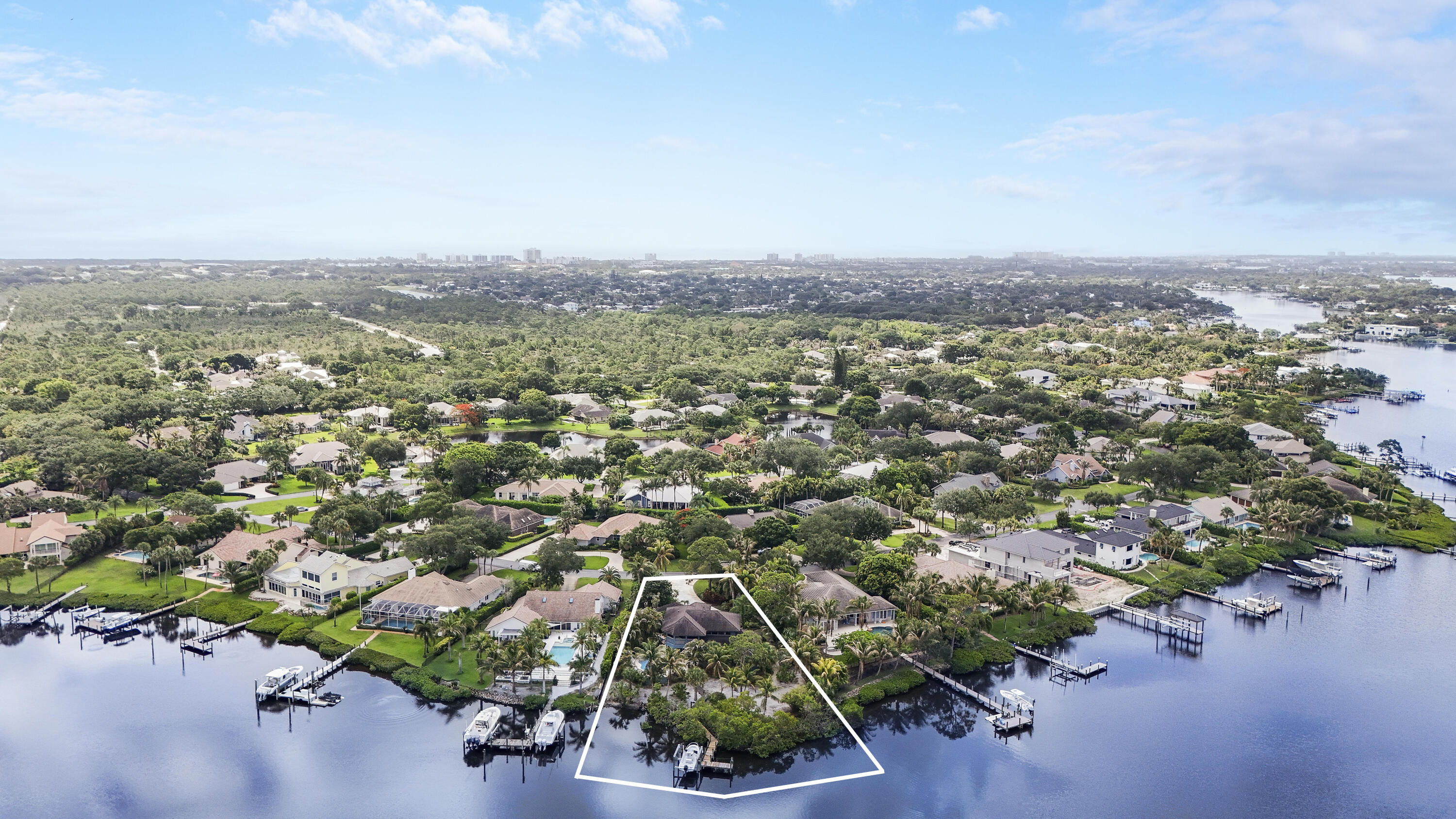 Build your dream home on one of the most desirable waterfront properties in Jupiter's exclusive River Ridge community. Situated on an expansive .53-acre waterfront homesite—the third-largest waterfront lot among just 43 waterfront residences—this rare offering provides the perfect canvas to create a custom estate tailored to your lifestyle with 120 feet of waterfrontage.  Enjoy scenic water views, breathtaking sunsets, and the advantage of lower Martin County taxes, all while being just minutes from the best of Jupiter. With direct boating access to the Loxahatchee River, Jupiter Inlet, and the Atlantic Ocean, this property is a true boater's paradise. The oversized lot offers exceptional privacy and endless possibilities for creating a resort-style backyard complete with a pool, outdoor e ntertaining spaces, and private dockage. Spend your days fishing, cruising to waterfront restaurants, or exploring the area's pristine waterways, all from your own backyard.  Nestled within one of the area's most sought-after boating communities, River Ridge offers a tranquil setting surrounded by natural beauty while remaining conveniently close to beautiful beaches, championship golf courses, shopping, and dining. Opportunities to build a custom waterfront estate on one of the largest lots in the community are exceedingly rare.  River Ridge is a vibrant waterfront gated community of 173 home sites located in Tequesta, Florida. Forty-three homes are situated along the North Fork of the Loxahatchee River, offering direct ocean access for boating enthusiasts. Residents enjoy a 24/7 manned guard gate, community clubhouse, tennis and pickleball courts, and the benefits of a low HOA. All of this while enjoying the lower taxes of Martin County, yet just minutes from Jupiter and Tequesta's beaches, golf courses, dining, and shopping.