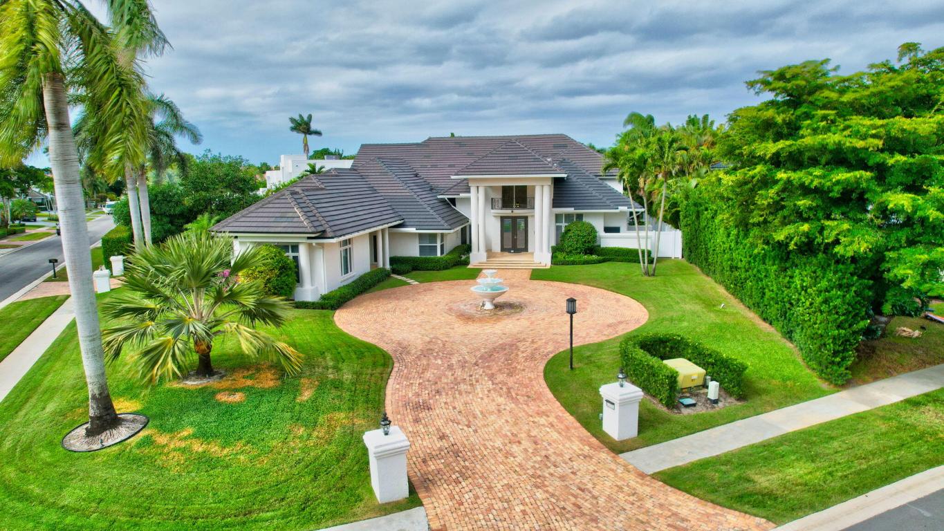 Nestled on over half an acre of lush, private grounds in the prestigious Boca Grove community, this magnificent 6-bedroom, 7.5-bathroom estate offers an unparalleled living experience. Every inch of this residence has been meticulously renovated to combine luxurious modern design with the highest quality finishes, ensuring a home of exceptional style and comfort. Upon entry, be greeted by the expansive living and dining areas, featuring soaring 24-foot ceilings and abundant natural light—an ideal setting for hosting large gatherings or intimate events. The gourmet kitchen is a culinary dream, outfitted with top-tier cabinetry, premium appliances, dual sinks, two dishwashers, a gas cooktop, double refrigerators and freezers, as well as a warming drawer. The spacious master suite  offers a private retreat with separate his-and-her bathrooms, both showcasing exquisite details and finishes. Upstairs, two generously-sized bedrooms with ensuite bathrooms provide privacy and comfort. Additionally, two more bedrooms are located on the main floor, while a fully appointed guest house with a private entrance offers a secluded quarters for visitors or extended family.
Step outside to discover true paradise. The custom oversized saltwater pool and spa are complemented by an Aqualink system, a new pool heater, and solar panels for energy efficiency. The lushly landscaped backyard is beautifully enhanced with Georgia grass, mature fruit trees, and full landscape lighting. Enjoy the outdoors with a charming gazebo, a louvered pergola, and a fully-equipped summer kitchen, perfect for entertaining or relaxing in your own private sanctuary.
This estate is further distinguished by cutting-edge smart home technology, including a Lutron lighting system, Sonos sound system, Flologic water shutoff system, and Ruckus Wi-Fi. Hurricane impact glass throughout and a full-house generator provide added peace of mind, ensuring protection and comfort no matter the weather.
This extraordinary property is a must-see to truly appreciate its beauty and design. Schedule your private showing today and experience the epitome of luxury living in Boca Grove.