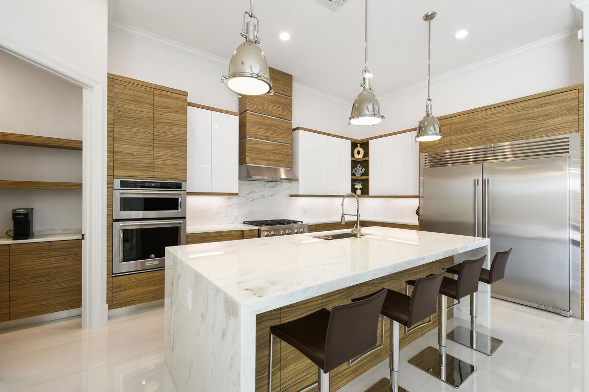 This totally renovated inside and out 4-BR, 4.5-BA custom designer pool home on one of the largest waterfront lots perfectly situated directly across from the clubhouse and all its amenities. Thoughtfully crafted with unmatched attention to detail, craftsmanship and high end finishes, this home also features a modern chef's kitchen with custom walnut cabinetry, a waterfall island, dolomite 6cm tops and a butler's pantry and wine fridge. Large format high gloss dolomite flooring, and much more!

The luxurious primary suite features real long plank white oak floors, a spa-like bath with a freestanding tub and oversized walk-in shower, and a large walk-in custom closet.  

Don't miss this masterpiece, offering unmatched features, craftsmanship, quality and much more at this price point.