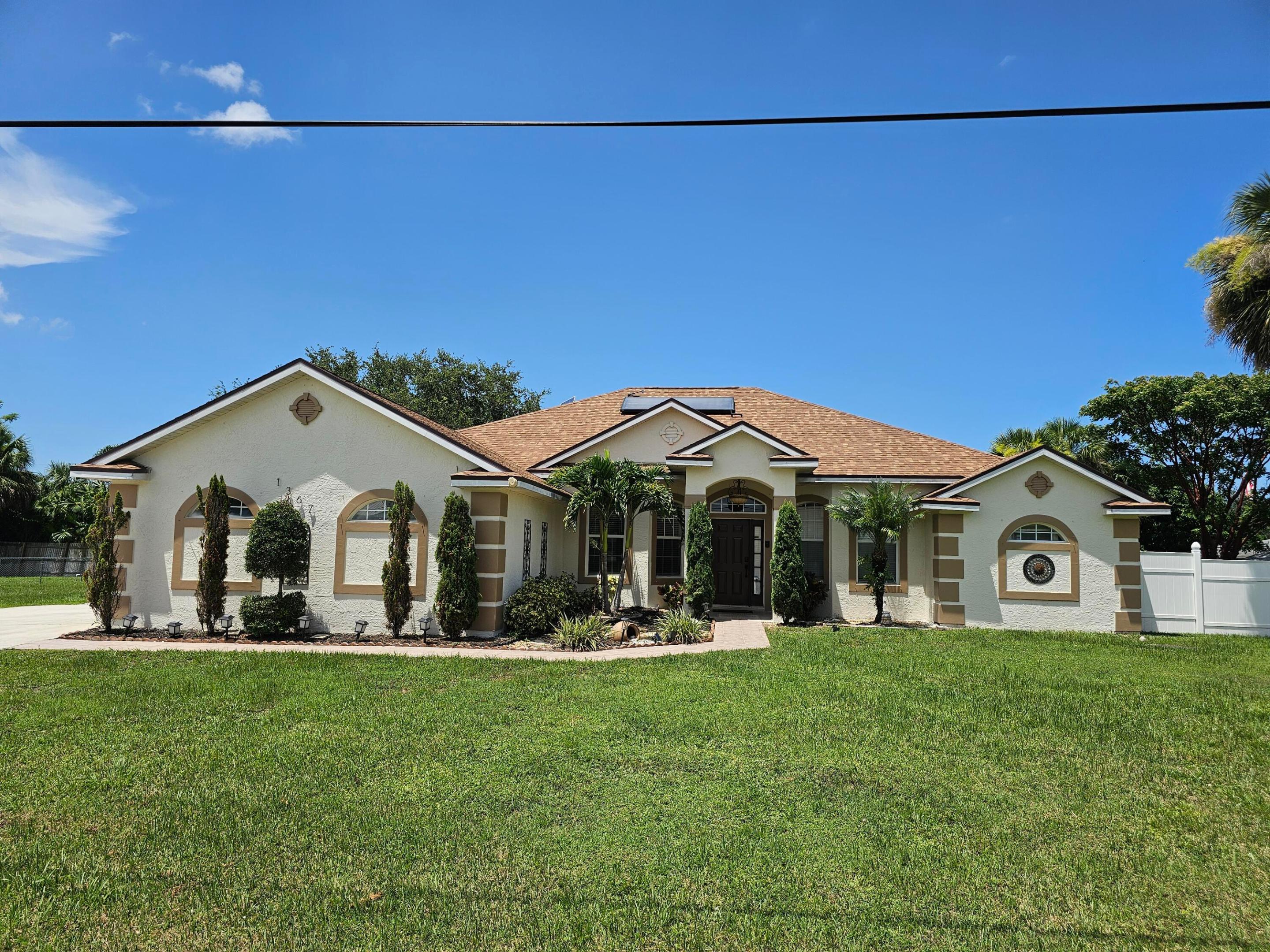 Beautiful 4BR/3BA home on a wide ½-acre lot with a split floor plan and room for your boat, RV, pool, shed, and family gatherings. Major updates include a new 2024 Roof, paid-off Solar Panels, New Hurricane Impact Windows, new solar water heater, and a new LG Smart refrigerator. Enjoy lower utility bills, a solar attic fan, 10' ceilings, formal living and dining rooms, an open-concept layout, tile throughout, granite countertops, 42" cabinets, stainless appliances with double oven, freshly exterior painted, bonus room, and a spacious primary suite with soaking tub and separate shower. 2019 high-efficiency A/C. Fenced backyard. Minutes to shopping, dining, beaches, Tradition, and major highways.