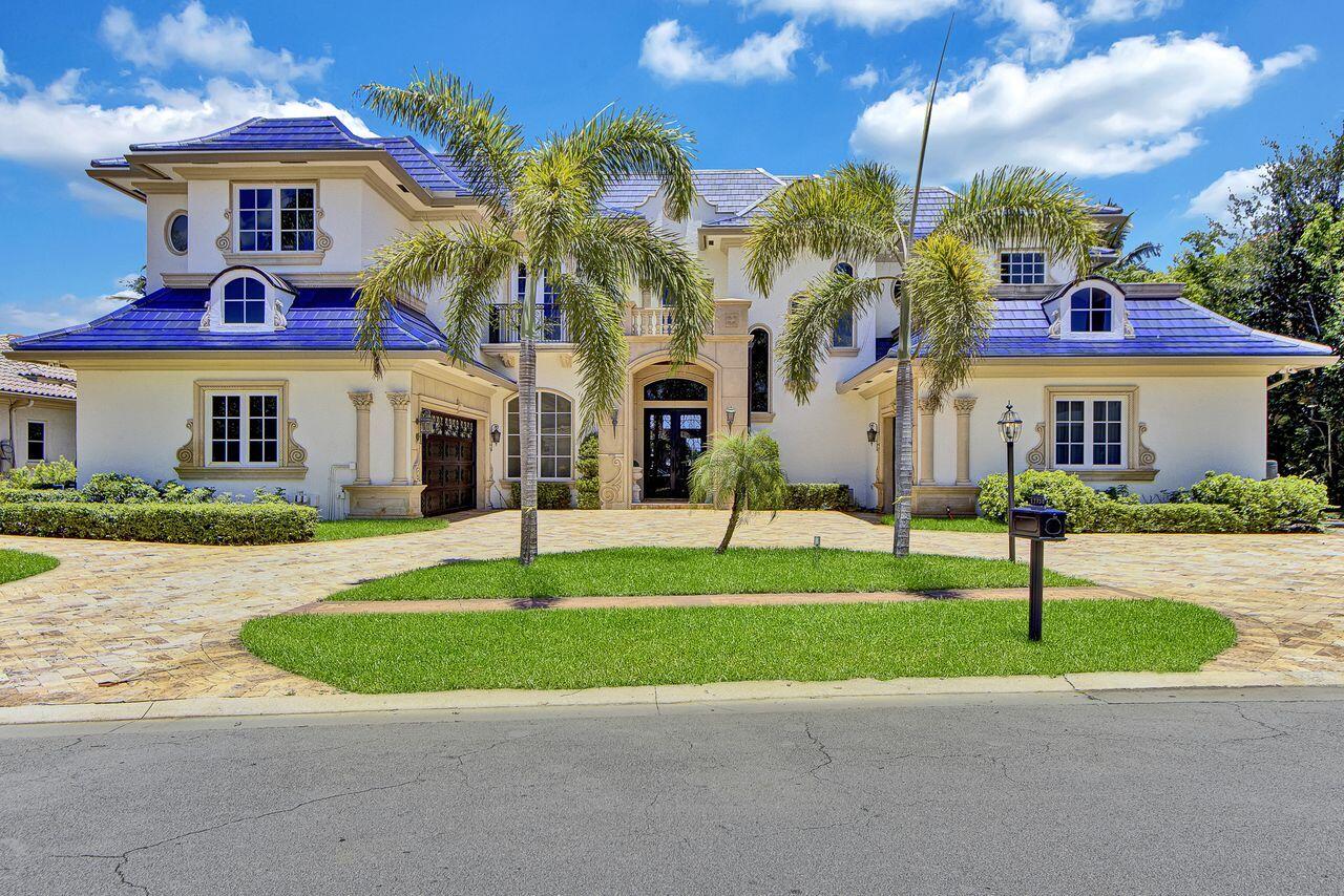 Commanding serene lakefront and double fairway vistas, this 2-story, 6 bedroom,7 1/2 bath estate embodies timeless elegance and European-inspired sophistication. Designed with extraordinary attention to detail, the residence showcases stately architecture,a custom royal-blue roof,and exquisite gold-inlaid finishes throughout.The grand living room impresses with soaring volume ceilings, a wood-burning fireplace, and a custom bar area that creates an inviting setting for elegant entertaining. The gourmet island kitchen combines beauty and function with light oak 42" cabinetry, granite countertops, tile backsplash, gas cooking, premium appliances, and a charming breakfast nook overlooking the water.The family room offers an elaborate entertainment center and detailed gold-accented ceiling ++ The primary suite on the main level offers a sanctuary of comfort and style, featuring walnut floors, dual custom-fitted closets, and separate his-and-hers bathrooms. The library exudes sophistication with built-in cabinetry, intricate ceiling detail, and tranquil lake views. A guest suite with full bath completes the first floor. A winding staircase and private elevator lead to the second level, appointed with a spacious loft, 4 additional bedrooms, and a media room designed for relaxation and entertainment. At the base of the staircase lies a 1,500-bottle wine cellar crafted for the discerning collector. The outdoor living space is equally impressive, offering a resort-style pool, spa, and summer kitchen overlooking the picturesque lake and golf course—perfect for grand-scale entertaining or serene retreats. Additional highlights include travertine floors in the living areas, Venetian plaster walls, custom stained-glass window accents, designer window treatments and lighting, a circular travertine driveway, impact windows and doors, and 2 laundry rooms. (Exclusions: Dining Room & Powder Room chandeliers, 4 Foyer sconces.)