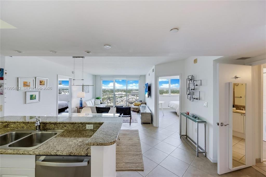 Updated 2BR/2BA residence with a desirable split floor plan at Turnberry on the Green. High-floor unit with open west-facing city and sunset views, private balcony, and wood-look flooring throughout living areas and bedrooms. Kitchen features granite countertops, white cabinetry, stainless steel appliances, breakfast bar, and full-size washer/dryer. Spacious primary suite with walk-in closet and en-suite bath. Impact windows and sliding glass doors. Located across from Aventura Mall and next to the Turnberry Golf Course walking trail, minutes from beaches, dining, Gulfstream Park, and major highways. Building amenities include 24-hour lobby, valet, pools, fitness center, sauna, BBQ area, playground, dog park, and assigned covered