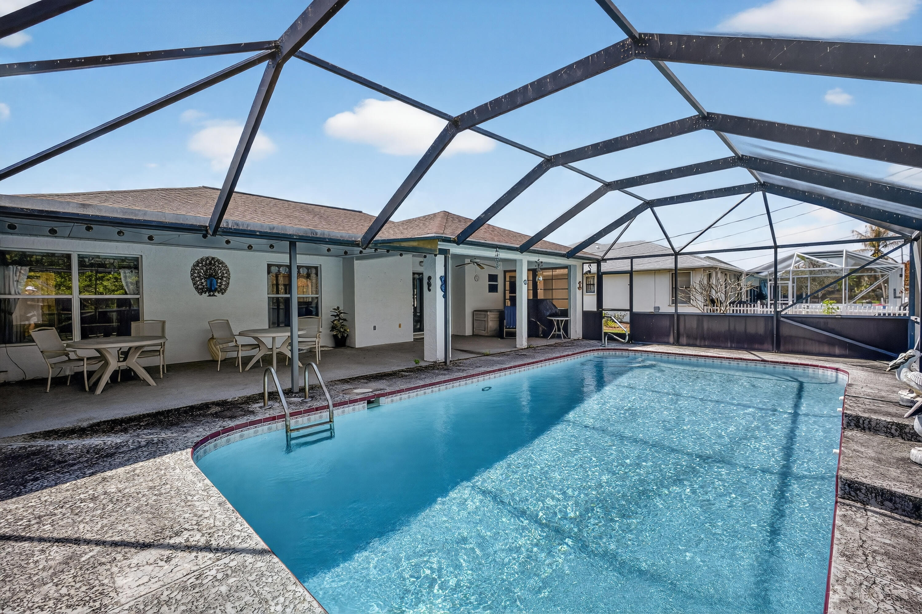 Located in the desirable Southbend Estates neighborhood of Port St. Lucie, this 3-bedroom, 2-bath pool home with a 2-car garage offers the perfect blend of space, flexibility, and Florida lifestyle. The open kitchen sits at the center of the home, overlooking the family room and the expansive 41' x 12' covered porch and screened pool area, ideal for entertaining or relaxing year-round. Formal living and dining rooms provide additional space and could easily be converted into a 4th bedroom, office, or playroom. Enjoy outdoor living in the private backyard with a large covered patio and pool. Southbend residents love the nearby Jessica Clinton Park featuring a public boat ramp with ocean access, ballfields, soccer fields, playground, and picnic areas! Convenient to FL Turnpike for commute.