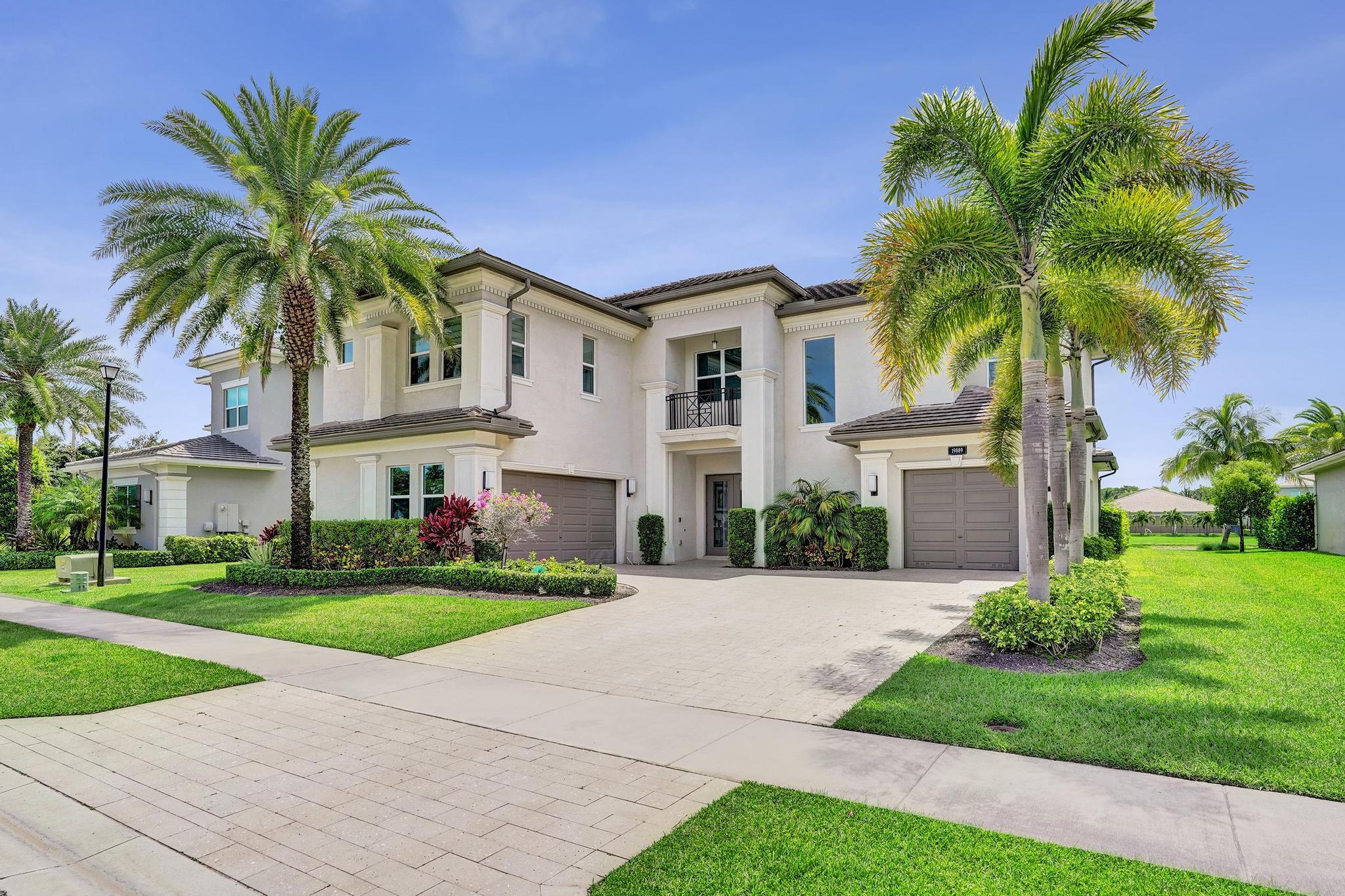 Discover elevated Florida living in this exceptional 5-bedroom, 7-bath lakefront estate offering approximately 5,800 square feet of living space in the prestigious gated community of Berkeley. Designed for sophisticated entertaining and everyday comfort, this residence blends contemporary elegance, refined finishes, and resort-style outdoor living. At the heart of the home is a stunning designer kitchen featuring premium stainless-steel appliances, upgraded Metropolis Ebony Ash cabinetry, quartz countertops, and an eye-catching mosaic backsplash. The expansive interior also includes a custom built-in bar with a dual-temperature wine and beverage refrigerator, while a dramatic 72-inch marble fireplace and designer accent wall create a striking focal point. Outside a private pool/spa.