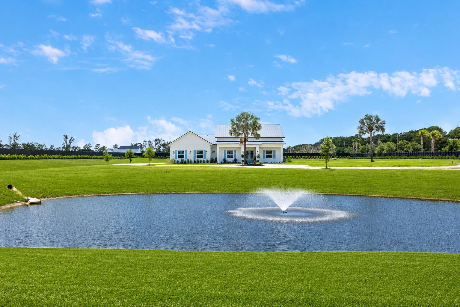 Rare opportunity to own a newly constructed modern farmhouse on 5 fully fenced private acres in Palm City with no HOA restrictions. This thoughtfully designed 5-bedroom, 5.5-bath residence offers 4,349 square feet under air with an open-concept layout, split-bedroom floor plan, spacious great room, oversized kitchen with large island and walk-in pantry, and an upstairs loft suite ideal for guests, media, or recreation. The private primary suite features a spa-inspired bath and generous closet space. Enjoy peaceful pond views, expansive outdoor living areas, and endless possibilities for a future pool, guest house, barn, detached garage, or additional recreational space. A rare blend of privacy, luxury, and flexibility just minutes from shopping, dining, golf, and major highways.