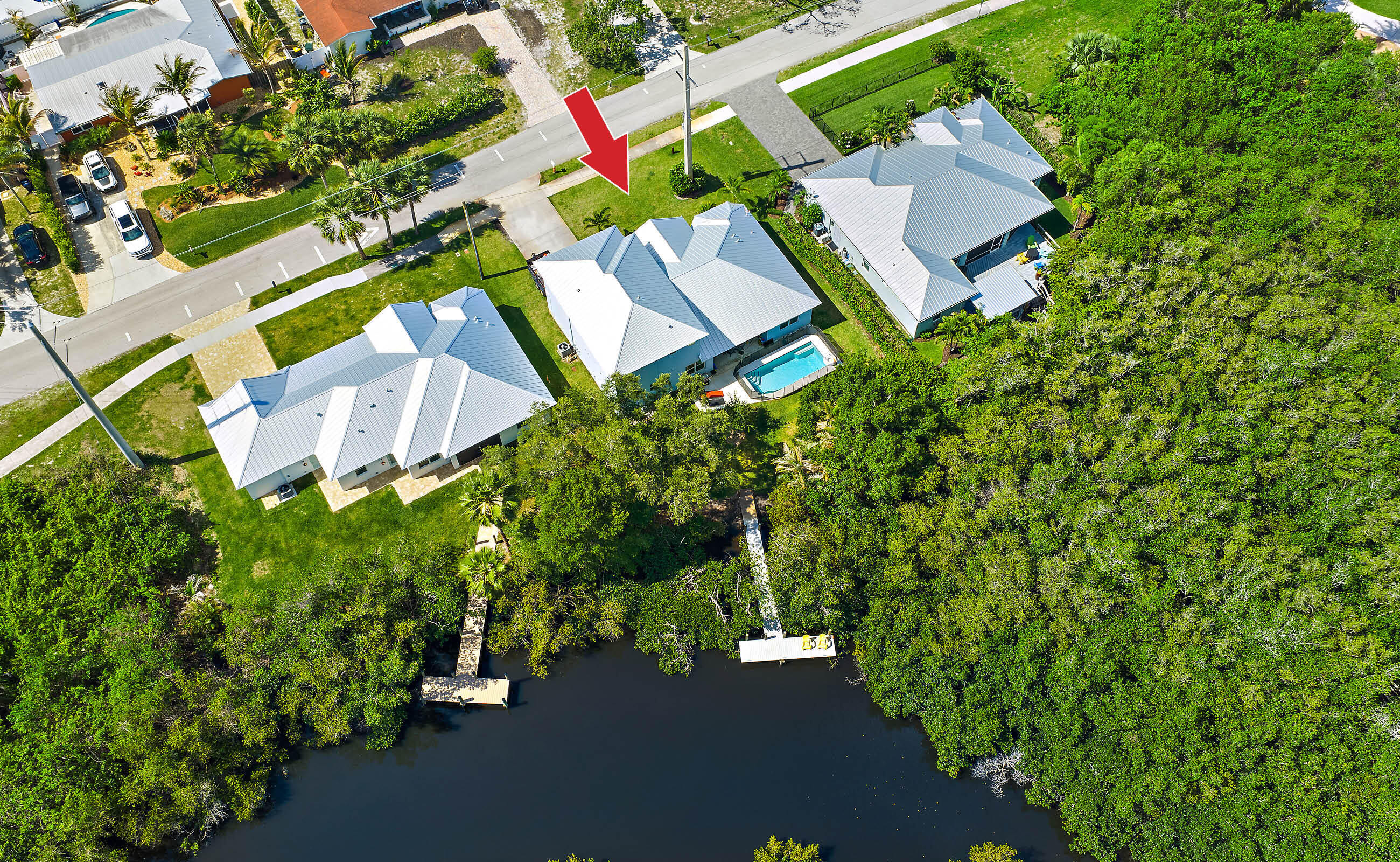 Enjoy the ultimate Florida waterfront lifestyle in this newer custom-built estate home (2023), just minutes from charming Downtown Stuart! Featuring impact glass windows and doors, high-end designer finishes, a private pool, and composite dock perfect for paddle boarding, jet skiing, kayaking, or a small boat. The first-floor owner's suite offers oversized walk-in closets, soaking tub, oversized shower, and pool/water views. Chef's kitchen includes upgraded appliances, abundant storage, and oversized pantry. Three guest suites upstairs. No HOA. Ideal as a full-time home, vacation getaway, or potential VRBO opportunity.
