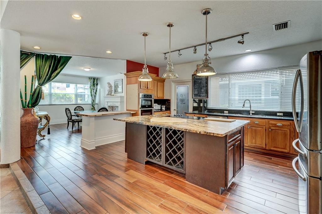 Looking for a HUGE GUEST HOUSE??Pack your bags, this stunning 5/3.5 plus loft corner lot, pool home features an attached guest house with a living room/kitchen combo & separate bedroom (it also has its own entrance). Great In-law suite or rent as Airbnb & pay the majority of your mortgage! This is a Gold Mine! 1st floor boasts a huge master w/custom walk-in closet plus another spacious guest room. Chef's Dream Kitchen! As you make your way up the stairs, it’s fit for a Queen! Current owner made an add'l closet (you gotta see this!) plus two add'l guest rooms. The storage area is a Harry Potter dream! This home is like nothing you have ever seen before, surrounded by beautiful landscaping! All impact windows, 2021 triple-split AC & Water heater, As well as a Newer Roof! Cash Cow with this attached quest quarters! This is great when you need to bring your parents to live with you and they need their independence.