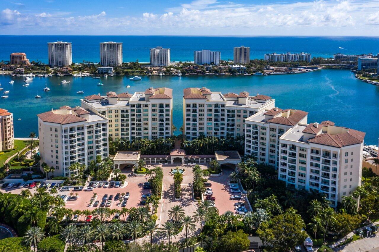 The crown jewel of Mizner Grand, this completely reimagined double penthouse offers an extraordinary waterfront lifestyle overlooking Lake Boca. Spanning over 8,400 square feet, this one-of-a-kind 5-bedroom, 5 full and 2 half bath residence showcases soaring 12-foot ceilings, expansive entertaining spaces, and impeccable design throughout. This masterfully envisioned penthouse reflects a curated blend of sophistication and craftsmanship, with the finest materials and finishes at every turn. A private elevator entry opens to a grand living room with panoramic water views and an elegant wet bar, creating a stunning setting for both intimate living and entertaining. The chef's kitchen is thoughtfully designed with generous storage, a butler's pantry, and formal dining room. The residence features five spacious bedroom suites, including dual primary suites with luxurious baths, along with a family room, and media room. Expansive terraces capture sweeping vistas of Lake Boca, the Intracoastal, ocean, and city skyline, offering seamless indoor-outdoor living. Complete with four parking spaces and the exclusivity of Mizner Grand, this exceptional penthouse represents the pinnacle of Boca Raton luxury living.
