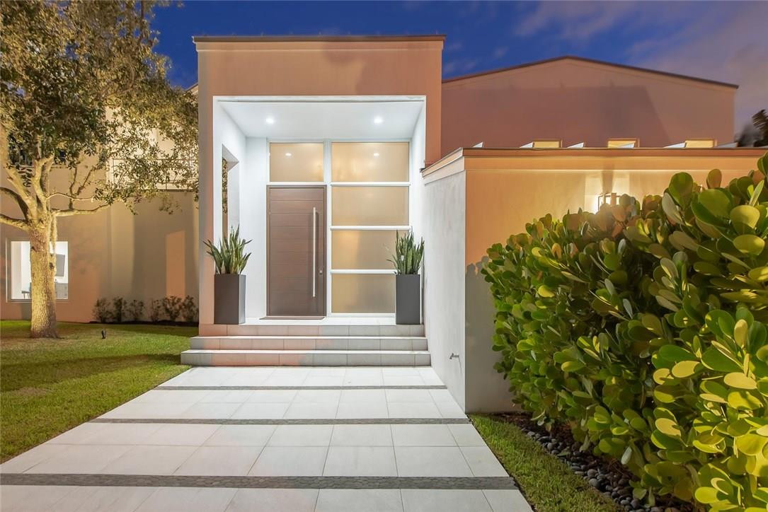 Fabulous Southeast Facing Home on WIDE Rio Barcelona. 95 ft waterfront at gated Sunrise Key, this home recently underwent a studs-in renovation incl: all new floors, lighting, kitchen and baths. Built for Florida, an entertaining home with multiple spacious gathering rooms, walls of impact windows and doors bringing the views inside. A tremendous master wing with 12 ft high ceilings, a sitting room and adjacent office. Balconies and terraces keep the outdoors near. A vast lawn and patio surround the pool.