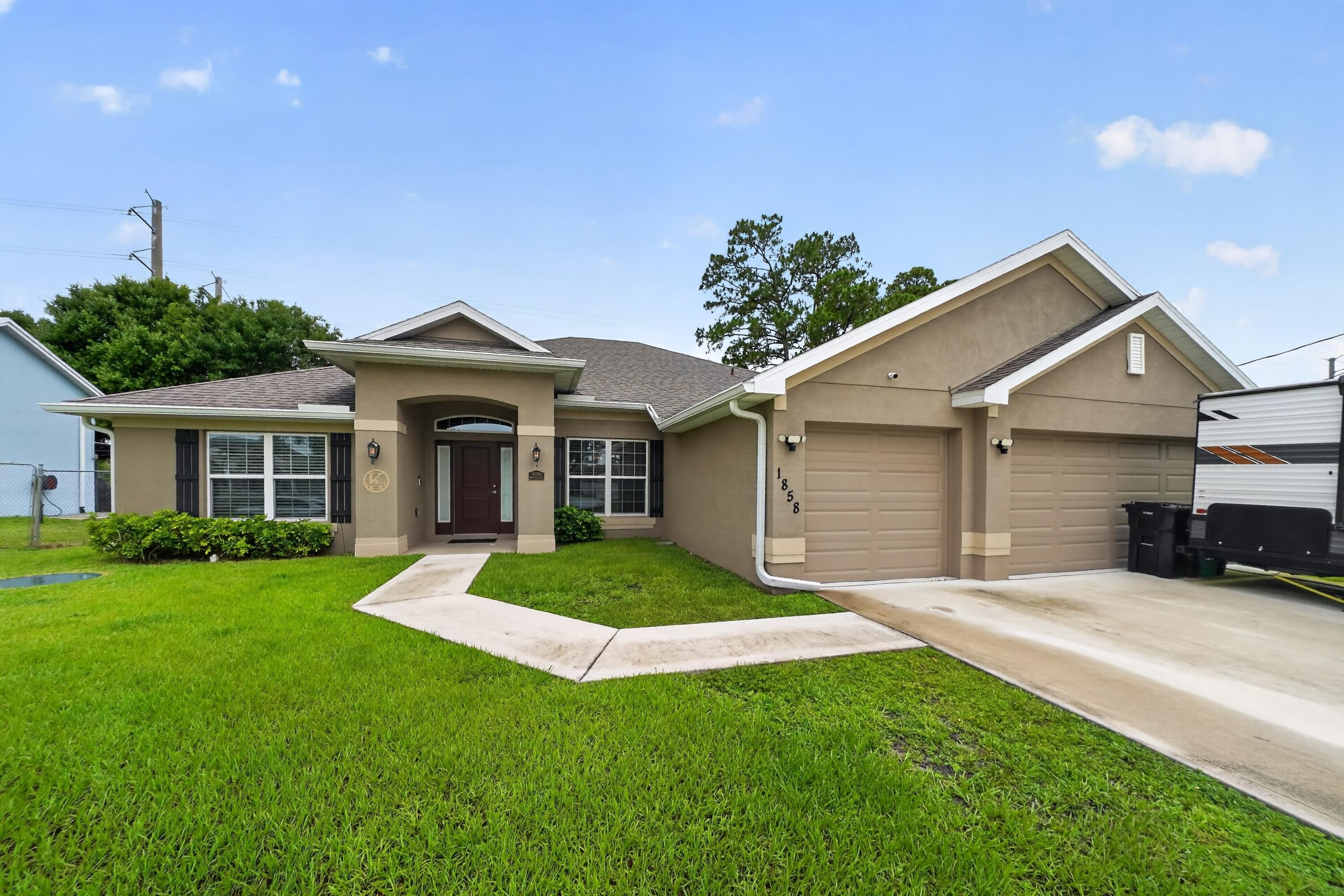 $70,000 Price improvement & Sellers ready to move this summer! Best value 2021 home with over $70,000 in upgrades including solar panels, a 3-car garage, an extended driveway, and an outdoor shed. Your next home features 4 bedrooms, 3 bathrooms, a flex room/den, and 2,508 sq. ft. of comfortable living space. Welcome to 1858 SW Mackenzie Street, just minutes away from I-95, Tradition & St. Lucie West with no HOA! Once inside, you'll find a split floor plan with an open layout providing natural lighting, The kitchen overlooks the main living areas and opens seamlessly into the hallway. Open the sliding doors and step outside to enjoy the screened-in lanai, a backyard with storage space and room for a pool, and the occasional views of wildlife. Built for any lifestyle, this home has it all!
