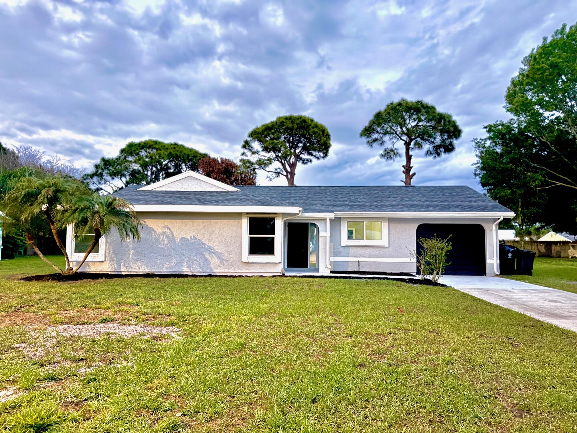 BRAND NEW ROOF, NEW A/C SYSTEM, FULLY RENOVATED .This beautifully updated home in Port St. Lucie features a full top-to-bottom rehab. Enjoy peace of mind with a brand new roof, new A/C system, new ductwork, and new water heater.  The interior boasts a modern design with fresh paint inside and out, brand new wood cabinetry, and elegant quartz countertops in both the kitchen and bathrooms. The kitchen and bathrooms feature ceramic tile flooring, with fully tiled shower walls for a clean, contemporary look. New Flooring  throughout the main living areas, offering durability and style. Home is centrally located, walking distance to  City Center, motor vehicle, Mid Florida Credit Union Event center, live music, festivals, shopping, finance, hospitals, worship. Beaches are 10-15 min car ride . steel appliances included. Perfect for homeowners seeking a turnkey property or investors looking for a low-maintenance asset. Conveniently located near shopping, dining, schools and roadways. Don't miss this opportunity to own a fully upgraded home in a desirable area!