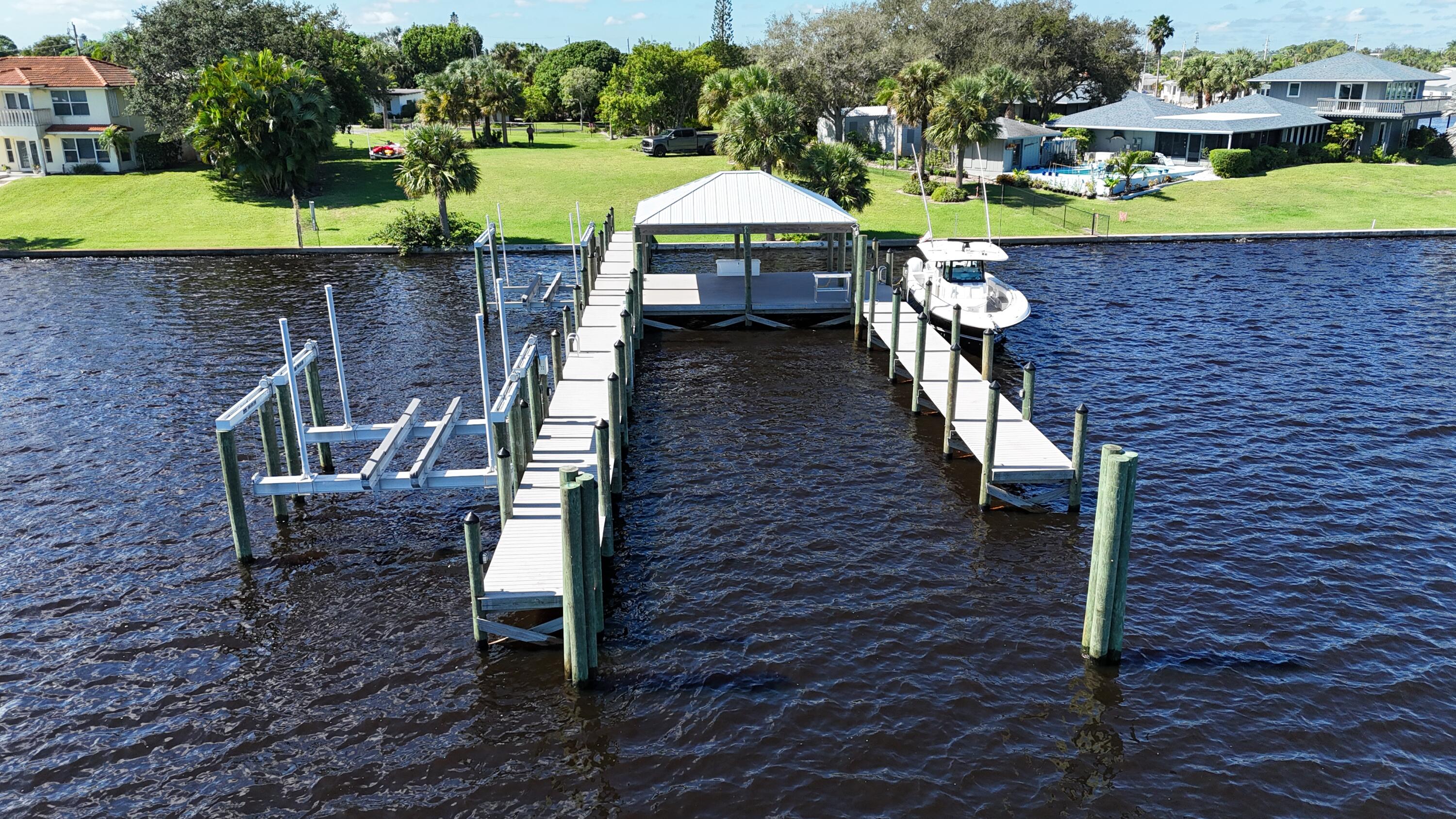 Welcome to 4345 SE Mulford Lane — a rare opportunity to own one of the most desirable waterfront parcels in Stuart, Florida. Perfectly situated in the Manatee Pocket with direct access to the Intracoastal and Atlantic Ocean, only 3 miles out. This property offers the ideal canvas to design your dream coastal residence. This expansive lot provides generous dimensions for a custom luxury home, resort-style pool, and private dock for 80' plus yacht with all electric and water in place with covered tiki area. With deep water and wide frontage, it's a boater's paradise — accommodating large vessels and providing quick access to open water. The property sits within a quiet, community tropical landscaping, and unbeatable proximity to Stuart's vibrant waterfront dining and marinas.
