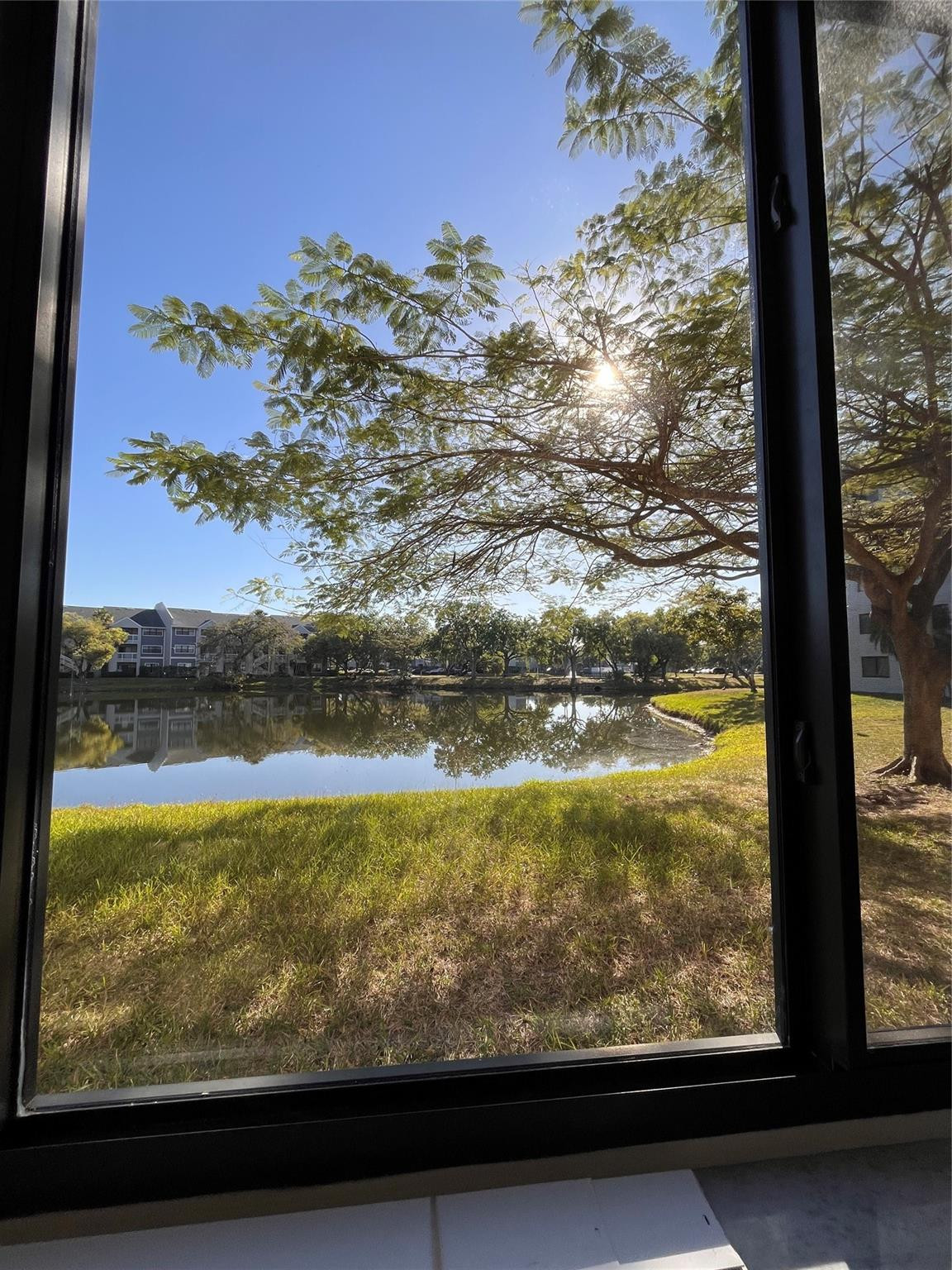 Large, oversized 2-bedroom / 2-bathroom unit featuring spacious walk-in closets, ample storage, and a dedicated laundry room. Fully tiled throughout, with a bonus office space or children’s play area. Impact windows in this first floor unit with a lake view, located in a well-maintained gated community.Amenities include:  2 pools, tennis court, pool table, and multipurpose room. Trash, pest control, basic cable, and internet are included.