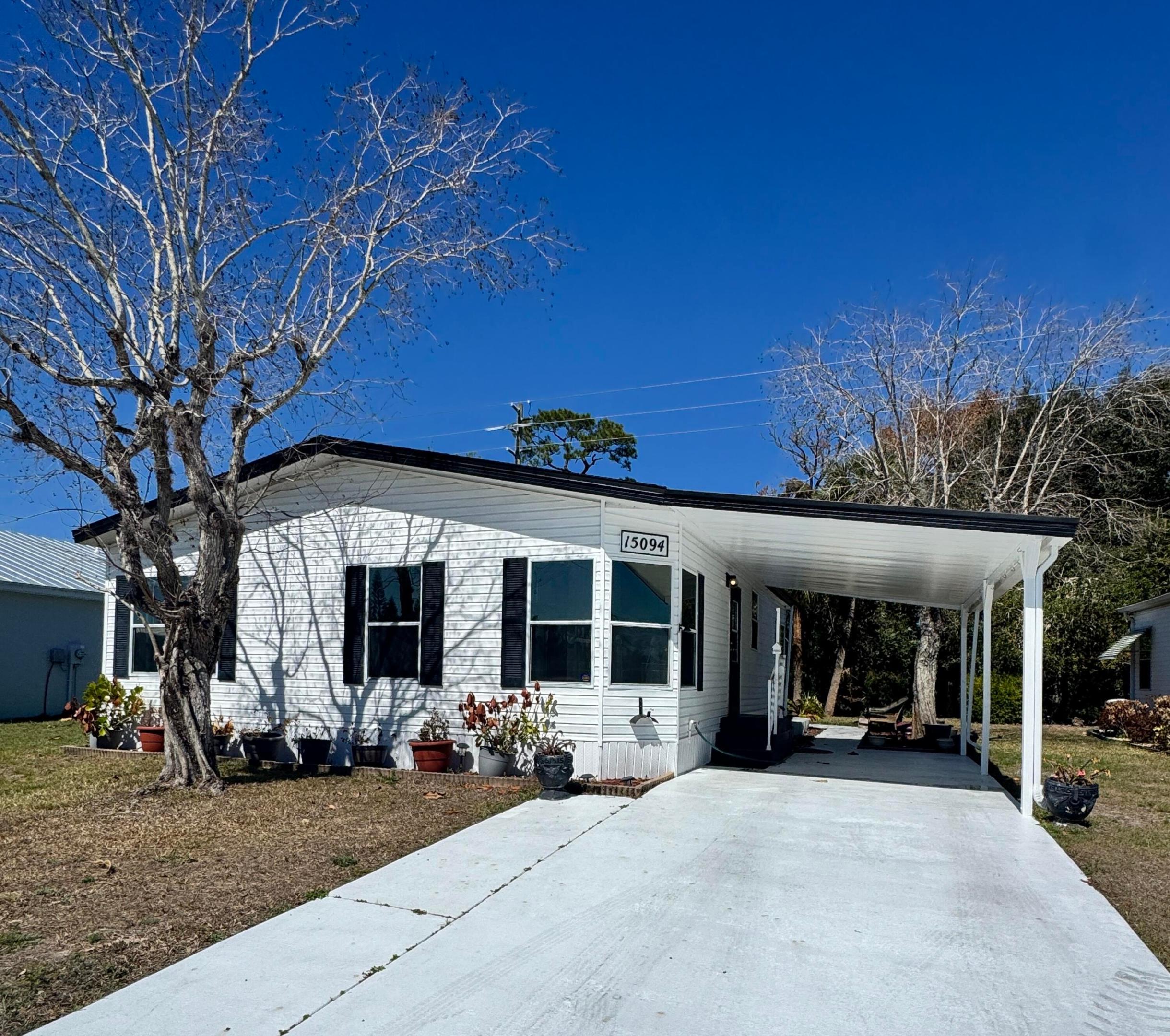 Well-maintained home in the desirable 55-plus community of Spanish Lakes Fairways. Home is at the back of the park with a very private backyard. 2-bedroom 2-bath home. newer laminate floors, no carpet. open kitchen with dinette area. Laundry is in the home. lovely back patio, great for morning coffee or evening cocktails.  Lawn care, trash removal, and golf are included in the lot rent. The community includes 2 pools, tennis, pickleball, bocce ball, and shuffleboard. clubhouse and much more. Must See!