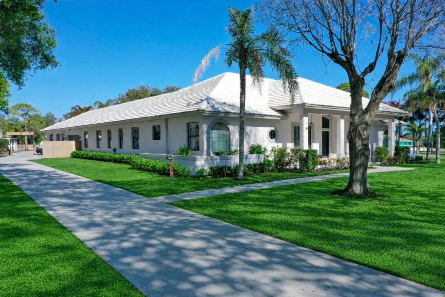 Looking for space for everyone & every thing? This fully renovated CBS multi-gen home features 5 bedrooms & 3 baths in main home PLUS an attached guest house with full kitchen + 2 bedrooms. Located on 3 acres with mature oaks, fenced yard and a massive 1,824 workshop. Bring your RV, Boats & cars - there's storage for them all!  For equestrian enthusiasts, the property also includes a 1,444 sq ft 5 stall barn with AC tack room & all new fencing with 3 paddocks.  This beautiful home features all new flooring, new kitchen with stone quartzite counters, freshly painted inside and out, all remodeled spa like bathrooms, new pool enclosure with new heater & pump, a summer outdoor kitchen that opens onto the enclosed lanai with pool - perfect for outdoor entertaining. Golf membership available -  Residents enjoy the option of non-mandatory membership to The Cape Club, a premier golfer's retreat offering exceptional golf and dining. Ideally located near I-95, with convenient access for north & south bound travel. Additionally, there is a 25 acre vacant lot adjacent to the property as for sale not subject to HOA rules. Combine this house with that lot for a truly remarkable equestrian property with trails and space for all of your animals & toys.