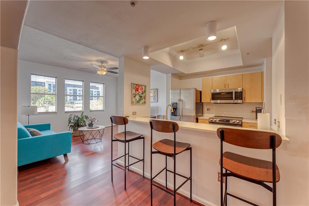 Updated 2/2 at Sole with a lot to offer! Newer quartz counters in kitchen with newer upgraded stainless steel appliances, pantry,great breakfast counter with seating and open to living space. Combination of beautiful laminate and engineered wood flooring throughout with tiles in kitchen & baths. Both bathrooms have newer granite counters & updated tiles in showers and bath tub areas. Space for small table or home office at entrance. Spacious living room with a lot of windows for nice natural lighting. Ample bedrooms w/big closets. Volume ceilings throughout, high impact windows. New water heater. Heated pool plus hot tub, BBQ grill, billiards,clubhouse,fitness center,onsite management, secured building,many building updates,WIFI,cable,water, sewer & trash included in condo fees. LOCATION!