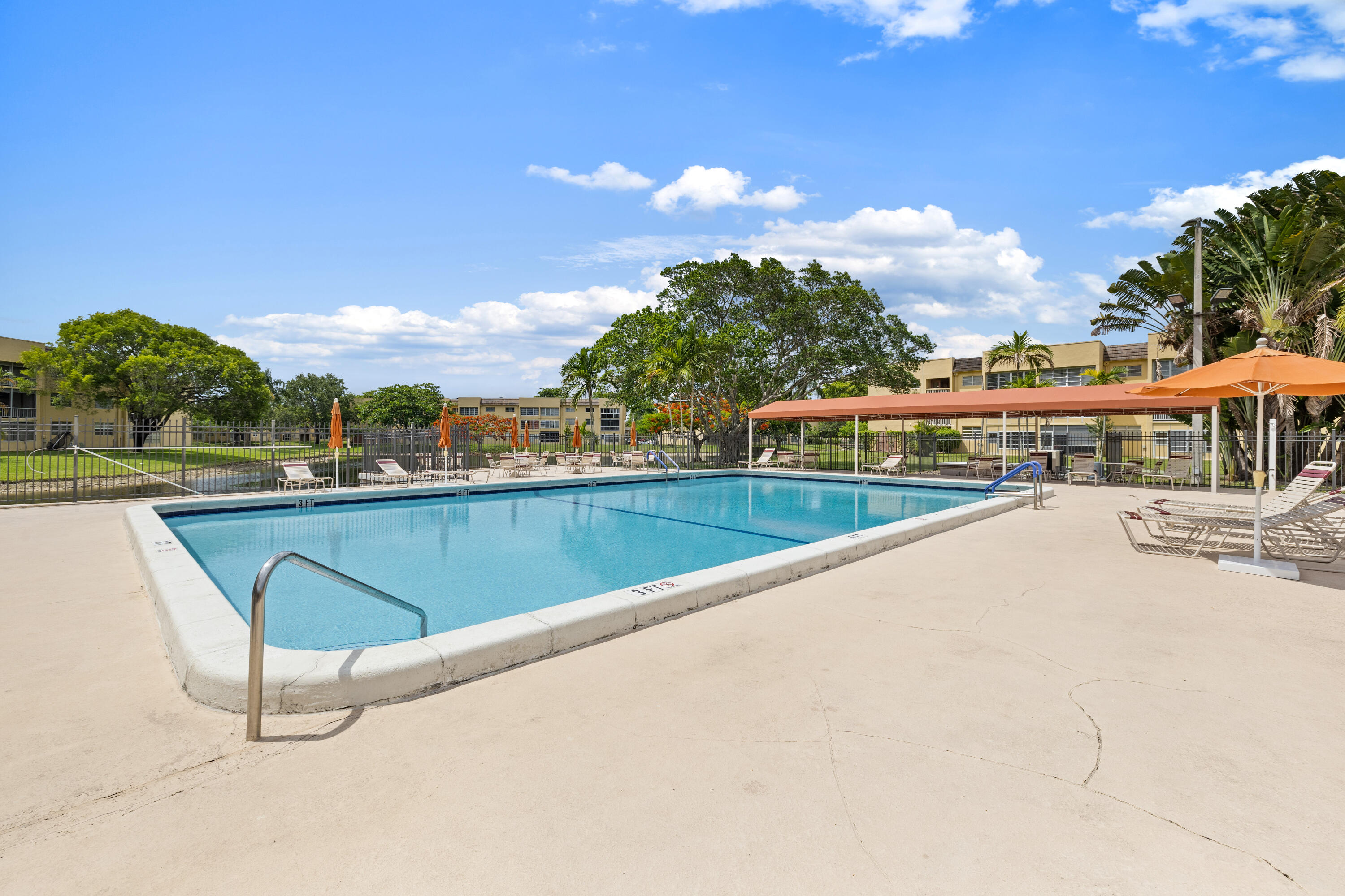 Beautiful 2-bedroom, 2-bathroom first-floor condo featuring an updated kitchen and renovated bathrooms. This light and bright unit offers tile flooring throughout and a spacious, comfortable layout. Enjoy additional living space with an enclosed patio, perfect for relaxing, entertaining, or a home office. Located within a well-maintained, mature community with lush landscaping and a welcoming atmosphere. Conveniently situated near shopping, dining, entertainment, and major highways, providing easy access to everything South Florida has to offer. A great opportunity for year-round living or seasonal enjoyment.