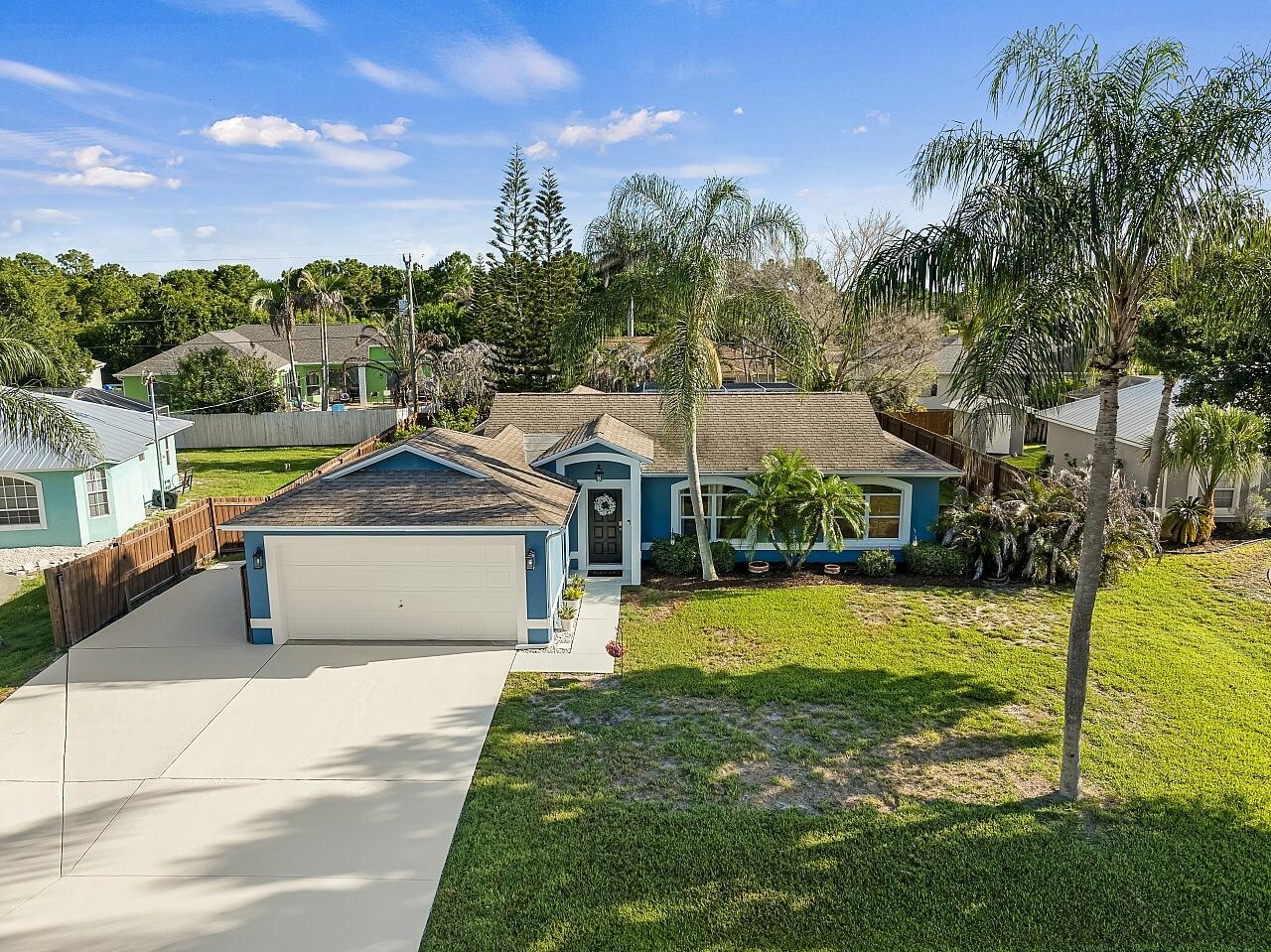 Sebastian Pool Paradise with Boat & RV Parking! Welcome to this beautifully maintained 3BR/2BA CBS home on a fully fenced .23 acre lot in one of Sebastian's most convenient locations. Enjoy the Florida lifestyle just minutes from Stormwater Park for walking trails and fishing, Sebastian Riverview Park with public boat launch, waterfront dining, shopping, and the Indian River Lagoon. Inside, you'll find a desirable split-bedroom floor plan with ceramic wood-look tile throughout and a renovated kitchen featuring white cabinetry, Corian countertops, subway tile backsplash, breakfast bar seating, floating wood shelves, and an open layout perfect for entertaining. The spacious primary suite offers a walk-in shower, while recent updates include newer HVAC, newer water heater, re-piped kitchen  and bath plumbing, and updated fixtures. Step outside to your private oasis featuring an oversized covered lanai, expansive screened pool enclosure, sparkling inground pool, and mature tropical landscaping for added privacy. The wide 2-car garage is complemented by an expanded driveway with dedicated side parking already in place for your boat, RV, trailer, or extra vehicles no costly additions needed. Proven Airbnb income potential makes this an excellent full-time residence, seasonal retreat, or investment opportunity. Experience the very best of Sebastian living!