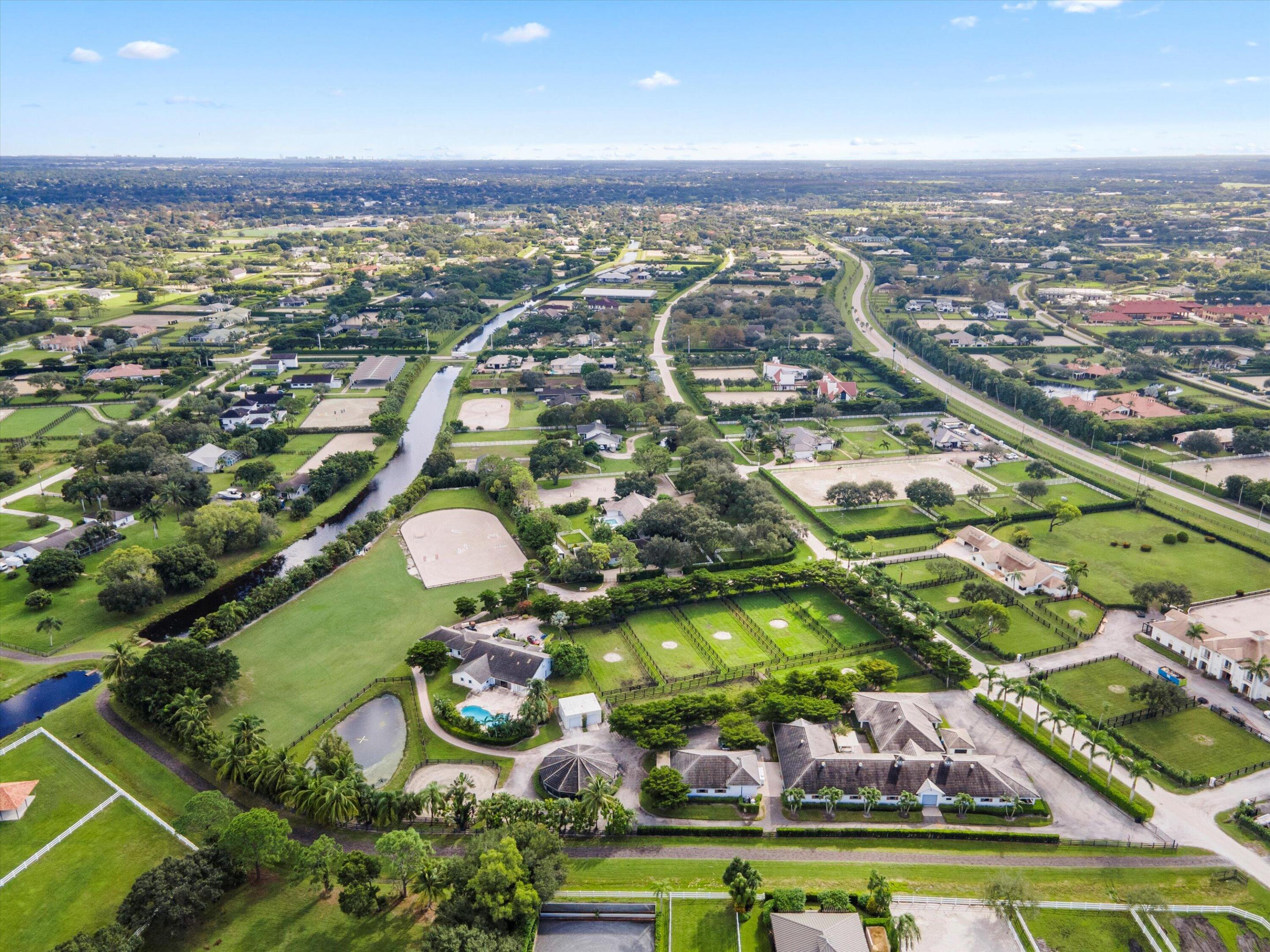 This 6-acre equestrian estate in Saddle Trail, is a top-tier facility for the professional equestrian, featuring 3 premium barns built in 2015 with 14,10 & 6 stalls respectively. All have extensive wash/groom stalls, feed rooms and tack rooms and feature Rower & Rub stalls. This facility comes with a solid lease income history. The arena is 115' x 215' fiber mix sub-irrigation with an adjacent 1 acre+ turfed grand prix field providing the ultimate in home site training. The 5 bedroom 3.5 bath pool home has a dedicated entrance. In total the property has 4 different entrances and great flow. The owners lounge with bathroom & kitchen provides a large social space. 7 large irrigated paddocks and a Kraft 6 horse covered walker. Property sits on the horse trail and is a true 15 min hack to WEF