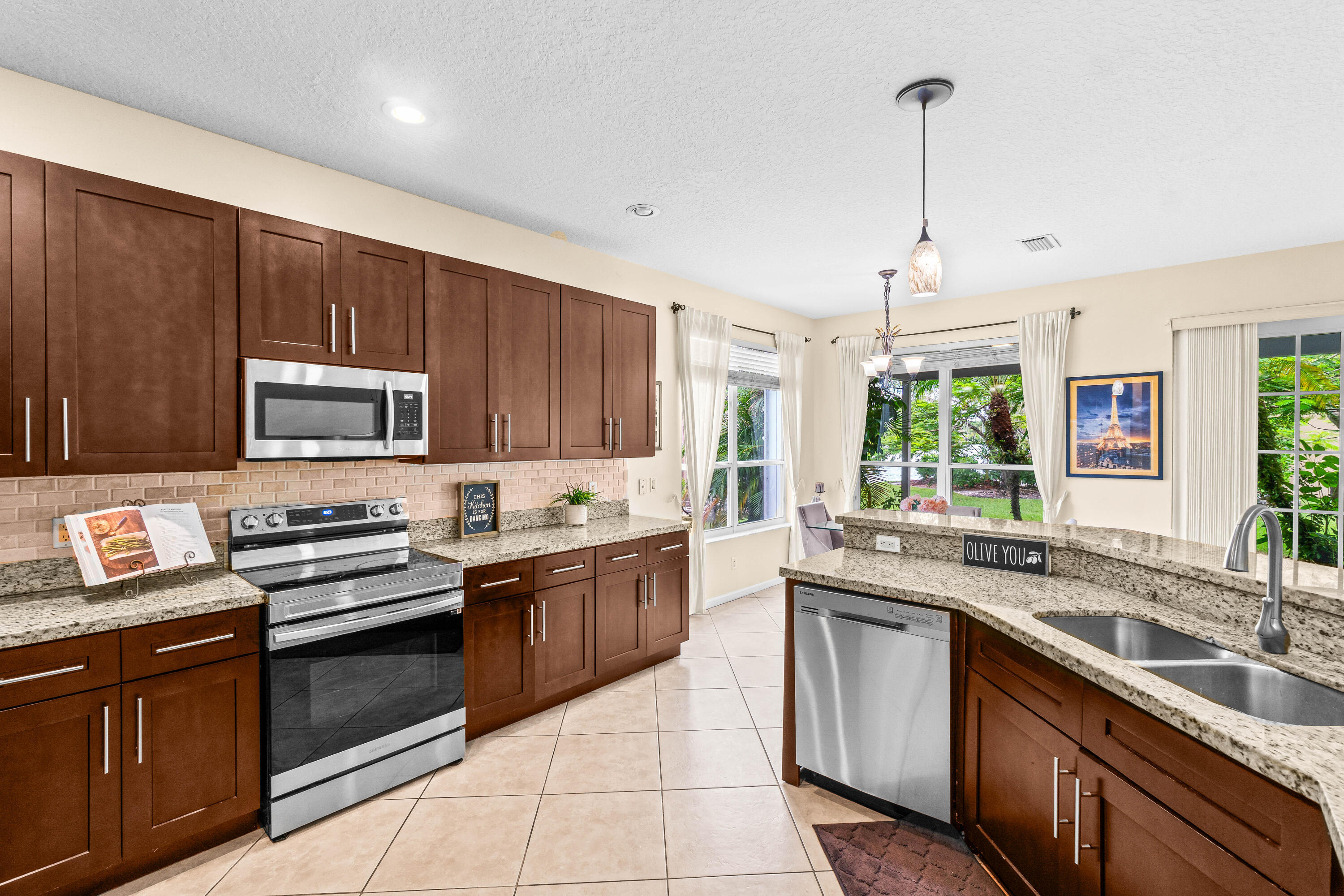 Welcome home to this light, bright, & spacious 5 bedroom + office, 3.5 bath single family home in beautiful Waterways of Boca Winds. Situated on an oversized pie-shaped corner lot w/ sparkling lake views, this nearly 3000 sq. foot home is ideal for both everyday living & entertaining. The flexible layout features a full bedroom & office downstairs, w/ 4 additional bedrooms upstairs, including the primary suite w/ gorgeous new spa-like primary bath. Add'l updates include a 2019 roof, full hurricane protection, a brand new 2024 hot water heater, dual a/c units, tile & laminate flooring throughout. This home sits on a 1/3 acre lot w/ tropical landscaping & a big backyard. Walking distance to community pool & part of a premier West Boca Community w/ great amenities. Walk to A rated schools.