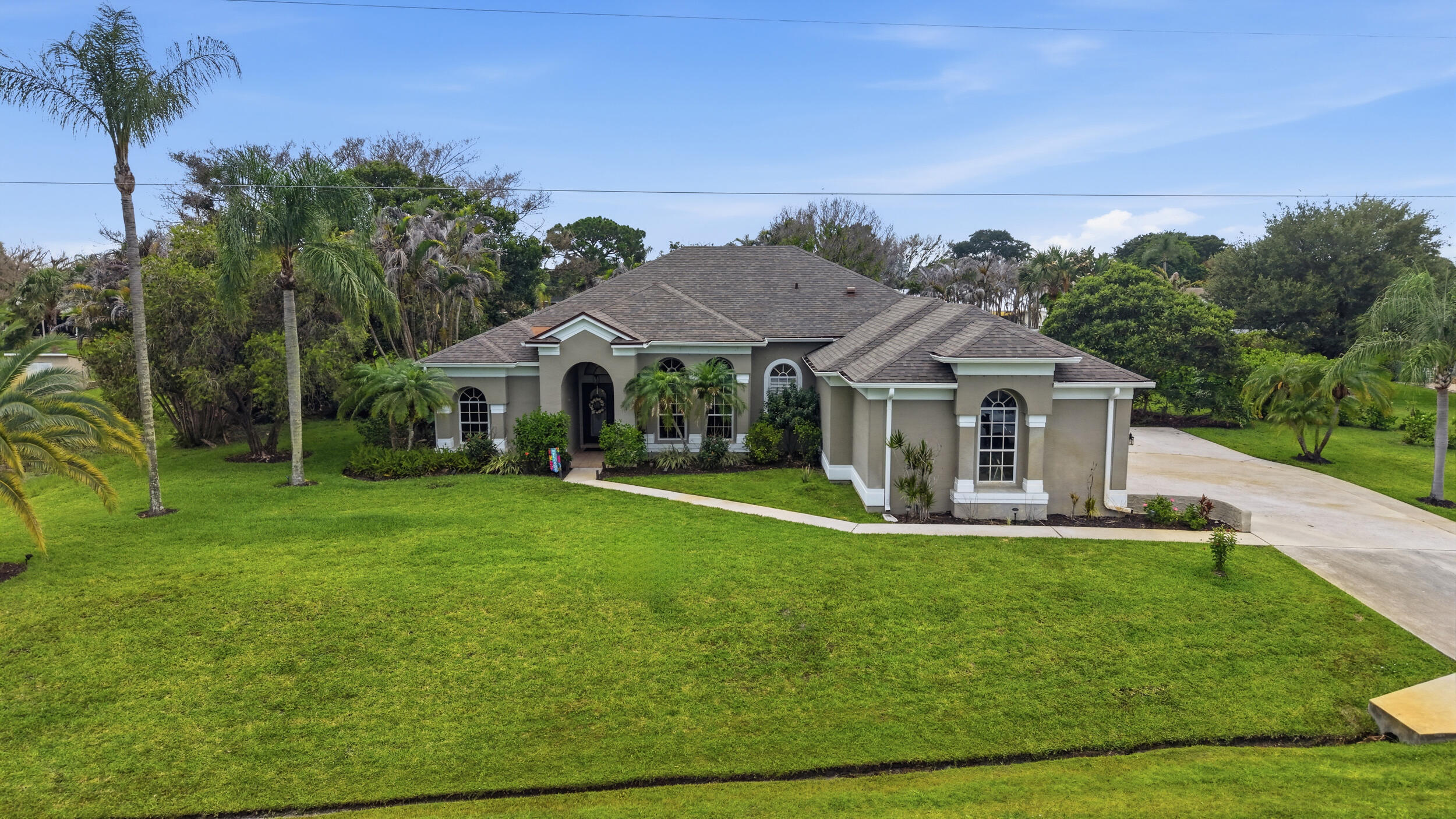 Remarkable opportunity in the highly desirable Sandpiper Bay community. Beautifully maintained and thoughtfully updated.  Prominent 4BR/3BA/3CG residence perfectly situated on an oversized estate lot and offers the perfect blend of comfort and elegance in over 2500 living sq ft. Brand new (1 month) roof, fresh interior paint, updated kitchen with S/S appliances, and luxurious renovated bathrooms. The split floor plan provides privacy, while formal living and dining rooms, a spacious family room, and breakfast nook create ideal gathering spaces perfect for entertaining. Step outside to a large screened lanai with an inground pool and spa, cabana bath access, mature landscaping, and a storage shed. Easy commute to major routes of transportation. Close to medical facilities, Jensen Beach, A rated schools, shopping and restaurants.