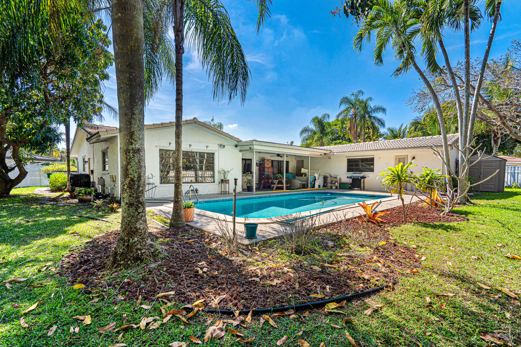 Rare opportunity located in the heart of Coral Springs, this Forest Hills gem sits on an oversized nearly~15,000 sq ft cul-de-sac lot w tranquil canal views. 4BR/2BA home features a wide-open floor plan, beautifully redone pool, stunning park-like backyard perfect for entertaining. The primary suite has been expanded by combining the 4th bedroom, creating a spacious retreat, and can easily be converted back if desired (tax records reflect 4 bedrooms). Owned and cared for many years, this home offers a great opportunity for updates and customization to match your personal style. Just a 4-minute bike ride to Forest Hill Elementary School & minutes to "The Walk" tons of dining, shopping, & more. Surrounded by parks & youth sports, this location truly captures the Coral Springs lifestyle!