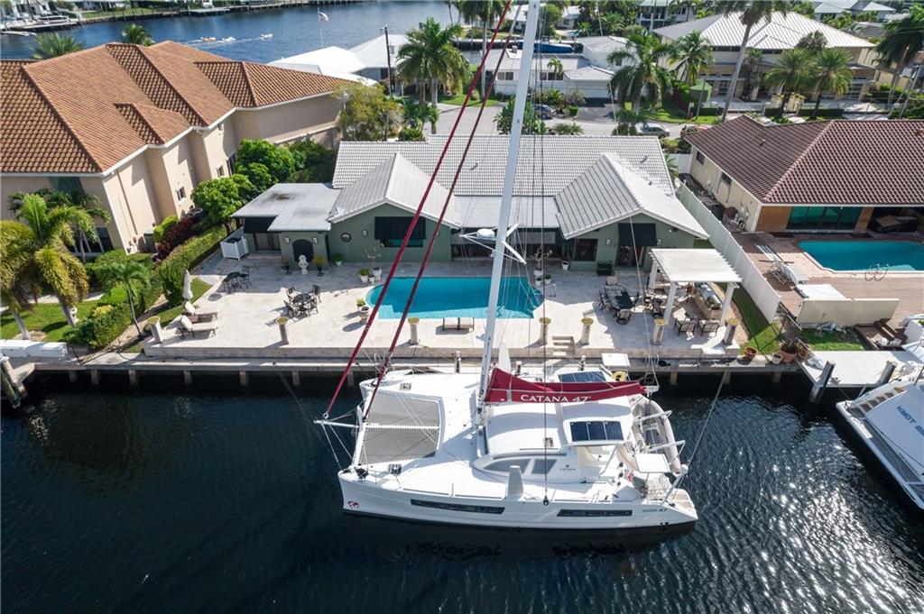 JUST NEWLY PRICED!!! "HOME IS WHERE THE YACHT IS!" Do not miss this incredible opportunity to purchase this impeccably appointed 4 Bedroom /3 Bath waterfront estate in sought-after Sunrise Key. Boasting 120' on the water with no fixed bridges to the Atlantic Ocean and just one in from the point with protected dockage for your motor yacht or sailboat. This move-in ready formal & elegant residence is a "must see" which is perfect for the buyer that wants it all now or an investor that wants a long/short term rental situation. Spacious rooms, light, bright and sliding windows galore open to outdoor entertaining areas. Grand Master Suite with 2 Master Baths (Her Master bathroom is absolutely stunning!), gourmet kitchen & open living areas await you! A true delight to show!
