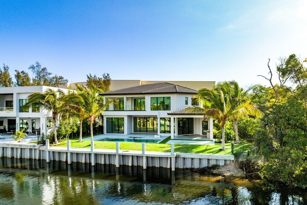 Discover the pinnacle of waterfront living at 530 River Oak Ln. This breathtaking 5br and 7ba 6,350 sq. ft. estate, where sophistication meets state-of-the-art design. Situated on an exclusive peninsula with a private drive where only 4 homes exist. Meticulously crafted with custom-built cabinetry and an open-concept chef's kitchen, this residence boasts top-of-the-line professional appliances, quartz countertops, and captivating water views. Every detail has been thoughtfully curated, from the six-foot-wide Italian porcelain tile to the Lutron smart lighting system, full-home generator, fiber optic wiring, and private elevator. Designed for seamless indoor-outdoor living, two expansive covered loggias open to panoramic, long-water views, creating the perfect setting for entertaining or relaxation. The heated saltwater pool and spa invite you to unwind, while the fully equipped summer kitchen elevates outdoor dining to an art form. For boating enthusiasts, this estate offers over 200 feet of pristine waterfront, complete with a new private dock and seawall, accommodating multiple vessels, jet skis, and water toys with ease. Rare opportunity to have usable waterfront in both the back and front of your home.  Only a short boat ride to Lake Boca and the Atlantic Ocean, this residence offers unmatched convenience and exclusivity. Perfectly positioned just moments to The Boca Raton & Boca Beach Club.  Developed by Nines Development and designed by RWB Luminares, this extraordinary home is a masterpiece of modern luxury. Experience waterfront living at its most refined. A sanctuary where timeless elegance and contemporary innovation come together to create an unparalleled lifestyle.