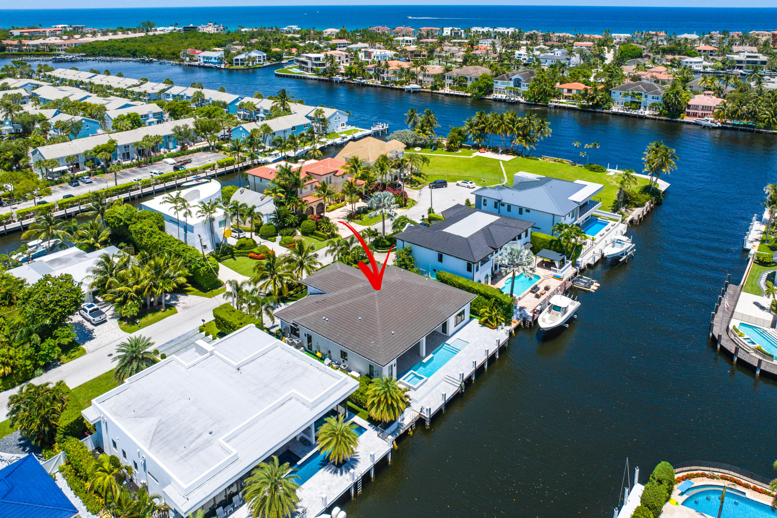 Experience the epitome of luxury living with this newly built, spectacular waterfront home in East Boca Raton. Upon entering, you're greeted by incredible water views of intersecting canals from the expansive windows in the living room. The home's luxurious architectural details include 12ft ceilings, crown moldings, a chef's kitchen with gas and Thermador appliances. The home also features a massive marble island, a dining area with water views, and a separate bar area adjacent to the living room. Smart home technology, surround sound, generator are just a few features this home offers. The resort-style pool and spa invite you to relax and soak in the sun or entertain guests in the outdoor summer kitchen. With 84 feet of prime dockage and a turning basin, this home is paradise