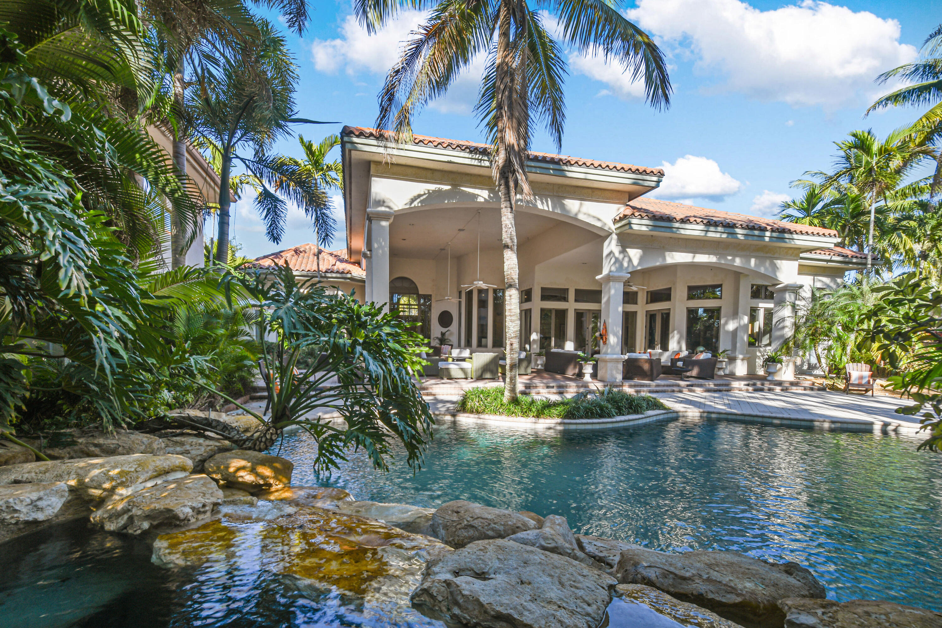 Magnificent Sprawling Estate with two Story Guest House & additional private Guest Suite located above the garage, all situated on 1.2 lushly landscaped acres, located within the exclusive gates of Steeplechase in Palm Beach Gardens, Florida.
This custom built residence offers six bedrooms and six full baths plus one half bath in the main compound plus one bedroom, soaring two story living room plus loft area & full bath in the detached guest house. 
Upon entering the main house from the grand circular driveway, you encounter soild wood entry doors opening into the  formal living and dining rooms with elaborate crown molding & ceilings  overlooking the lush grounds & pool area. 
A true chef's kitchen awaits the discerning chef with large center island: *Imperial commercial gas stove w/ six burners and oven
*4 sub zero refrigerator drawers & sub zero refrigerator
*Thermador double convection wall ovens
*Wine storage and large pantry for elaborate entertaining

An oversized family room with bar area opens to the kitchen area for collaborative entertaining and living, while featuring oversized glass doors opening onto the expansive pool area.

This fabulous home is host to a large master en-suite with opulent master bathroom, double side walkin shower and seperate large jacuzzi tub plus two large walk-in closets.

Other amenities include:
* Private gym for the fitness enthusist
*Office with dark wood built-ins & French doors
*Attached private guest en-suite on the second level above garage adds privacy for family or friends and includes an oversized entertainment/family room
*Full House propane gas generator that runs main house plus guest house
*7 AC units
*2 buried propane gas tanks 
*3 car garage
*Master suite on ground level


MAIN HOUSE- 9396 TOTAL SQUARE FEET/ 7268 LIVING SQUARE FEET 
GUEST HOUSE- 2533 TOTAL SQUARE FEET/1553 LIVING SQUARE FEET

Guest House-extradordinary two story guest house with oversized living area, soaring ceilings and all windows for bright Florida living.  Loft area upstairs plus bedroom and bath on lower level, all opening to the lagoon style pool.


The magnificent grounds feature over 1.2 acres of lush, private landscaping and huge L-shaped covered Lanai area for great outdoor entertaining: features include outdoor seperate  summer kitchen structure with bar and heated lagoon pool with stone waterfall and hottub heated by electric or propane gas, chlorine pool.

The estate is adjacent to canal with water access. Words cannot describe the palatialness of this magnificent home