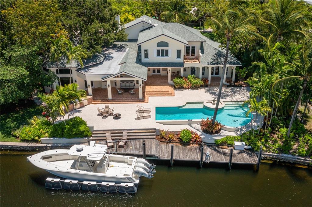 Situated on the banks of the quiet Tarpon River in Fort Lauderdale, this extra-large home is set deep within the heart of exclusive Rio Vista. The house is currently set up with 5 bedrooms, plus there is a full workout room and den, each ready to be converted into an extra bedroom with access to bathrooms. The extra-large eat-in kitchen (with Sub Zero refrigerator, gas range and arching tumble-brick surround) overlooks the adjacent family room and bar area with views of the waterway. There is a separate living quarters with office, bathroom, and a stand-alone kitchen, plus washer/dryer. Featuring plenty of covered loggia space, all overlooking the pool and river, outdoor areas abound. The house sits on an enormous lot, at over 19000 sq ft, with 147 ft of waterfront, and a three-car garage.