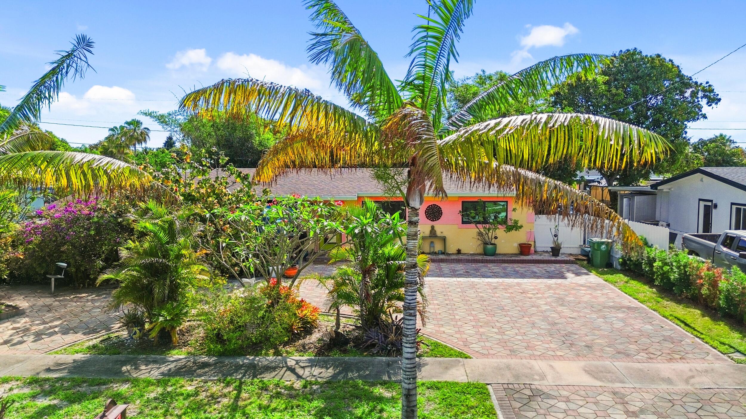 This charming home offers a spacious open floor plan designed for comfortable living and entertaining. Recent upgrades include a new tankless water heater, impact windows, and a roof installed in 2018, providing both efficiency and peace of mind. Situated on a generous lot, the property features an above-ground saltwater pool—perfect for relaxing and enjoying the outdoors.  Conveniently located near shopping centers and just a short drive to I-95, this home combines comfort with accessibility. The paved circular driveway provides ample parking, adding to the home's practicality and curb appeal.  A truly cozy and inviting property ready to welcome you home.    Escape to your own private tropical oasis—right in the heart of town. This one-of-a-kind 4-bedroom, 2-bath artist retreat offers a rare blend of serenity, creativity, and convenience. Lush fruit trees, swaying bamboo, and a tranquil koi pond create a peaceful, island-inspired setting from the moment you arrive.  Inside, the open-concept layout showcases unique architectural details, including carved ceilings and sculpted walls that add character and charm throughout. The thoughtfully designed chef's kitchen features modern appliances and a functional layout ideal for everyday living and entertaining.  Enjoy seamless indoor-outdoor living with an expansive covered lanai that opens to vibrant garden spaces—perfect for hosting, relaxing, or enjoying your morning coffee. The versatile fourth bedroom offers excellent potential for a private studio, in-law suite, home office, or guest quarters, with space for a future bathroom addition.  Set on a spacious lot with a large yard, quiet surroundings, and ample parking, this property offers both privacy and convenience just minutes from local amenities. A truly unique home that combines lifestyle, comfort, and artistic flair.