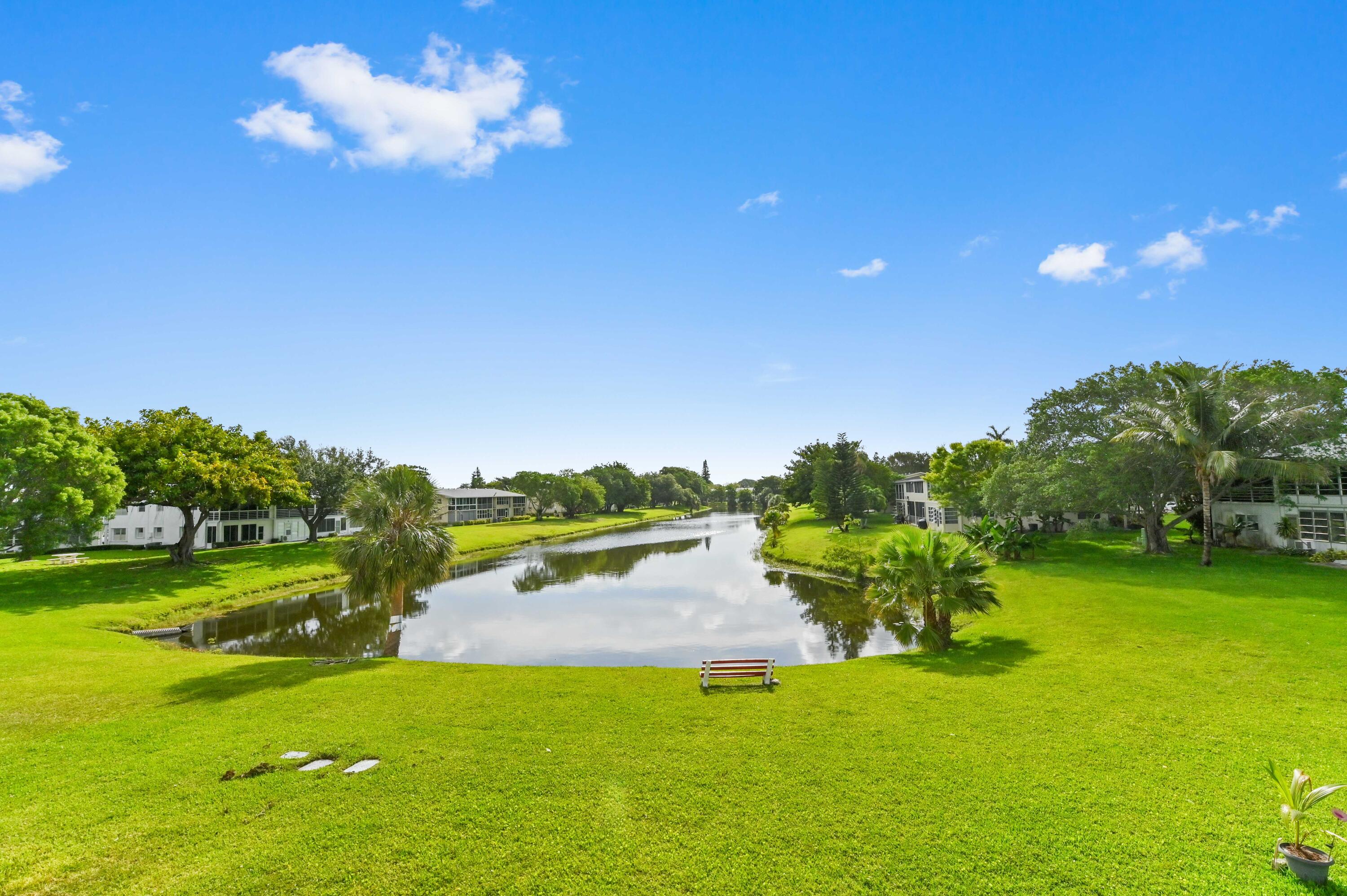 Beautiful 2nd floor 2 bed/1.5 baths lakefront condo with breathtaking wide lake views in desirable, gated 55+ community. This unit features ceramic tile floors, carpeted bedrooms & ceiling fans in every room. Spacious living room leads to dining area & kitchen to the left. Bedrooms are large, with plenty of closet space including 1 walk-in closet & en-suite bath in the primary bed. Patio & enclosed porch overlook serene water views—perfect for relaxing or entertaining! Conveniently located near the West Gate & within walking distance to the pool & park. Unit includes 1 parking space + guest spaces. Water & cable included in LOW MAINTENANCE FEE ($516/mo). Ok to rent after 2 yrs. of owning. NO SPECIAL ASSESSMENTS! Amenities include: pool, tennis, shuffleboard, billiards, library, gym & more!