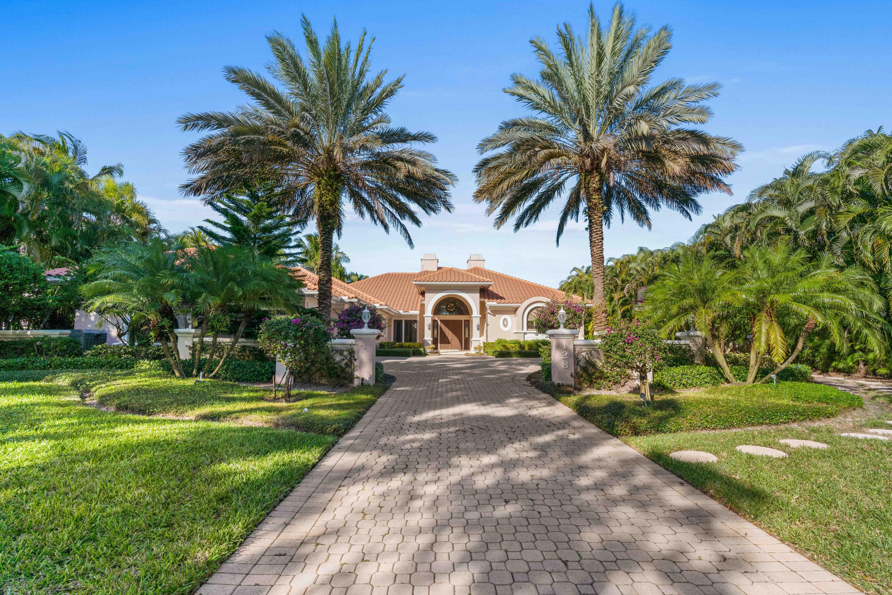 Enjoy wide water views in your backyard and serene golf views in front! Over a half acre on a favorite street in Admirals Cove, this spacious custom home features 5 bedrooms, 6 1/2 baths plus an office, and an attached guest house with a separate entrance, bedroom, bath, sitting room, and kitchenette. Spacious master suite, 3 bedrooms with en suite baths. Marble floors, 2 sided fireplace, volume ceilings, generator, kitchen with Wolf 6 burner gas range, wolf wall ovens, and warming drawer. Large backyard with 40' pool, 100 feet of water frontage, and dock for up to 70' yacht with quick access to ICW and no fixed bridges to ocean. This preferred location offers the rare opportunity to renovate or build your dream 11,000 sq ft custom estate. Required golf membership purchase conveys all the first-class amenities of Admirals Cove, including two spectacular clubhouses, 45 holes of golf, 5 restaurants, 58 slip marina with floating docks, a Yacht Club, 10 har tru tennis courts, 8 pickleball courts, state of the art fitness and wellness center with Technogym machines, 21,000 sq ft brand new spa & salon, 30 room Waterside Private Boutique Hotel for members and their guests, brand new Golf Learning Center, Covesters kids club and Platinum service.