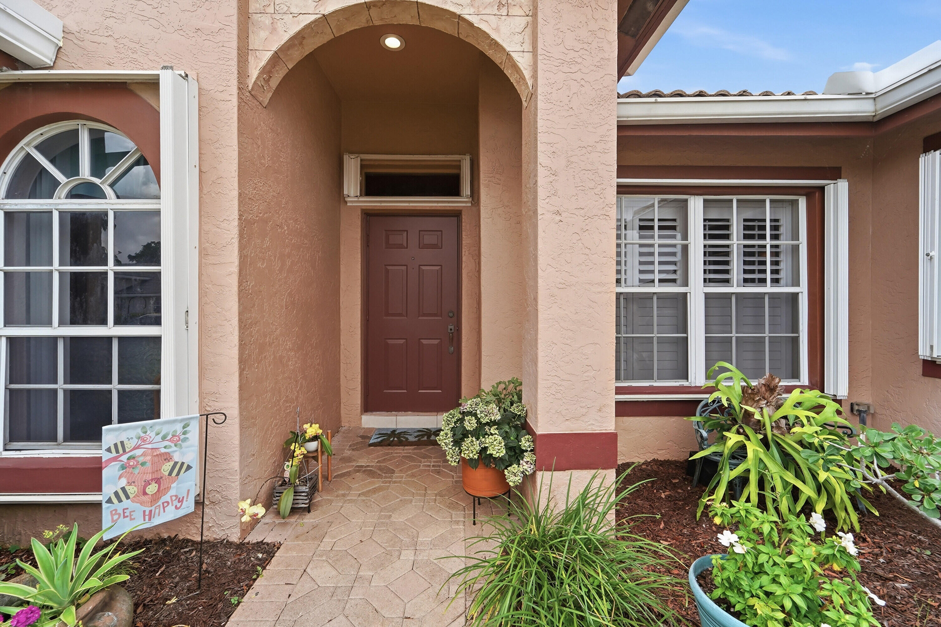 Welcome to this beautifully maintained 3-bedroom, 2-bath home in the desirable gated community of Cypress Creek. Offering over 2,000 sq ft of bright living space with soaring ceilings, this move-in ready home features an updated kitchen with granite countertops, stainless steel appliances, custom cabinetry, and plenty of storage. The spacious primary suite includes a walk-in closet, dual sinks, Roman tub, and updated shower. Relax or entertain from the covered screened patio overlooking lush tropical landscaping on a private quarter-acre lot. Complete with accordion hurricane shutters, a 2-car garage, low HOA fees, and a prime Boynton Beach location close to golf, shopping, dining, and beaches.