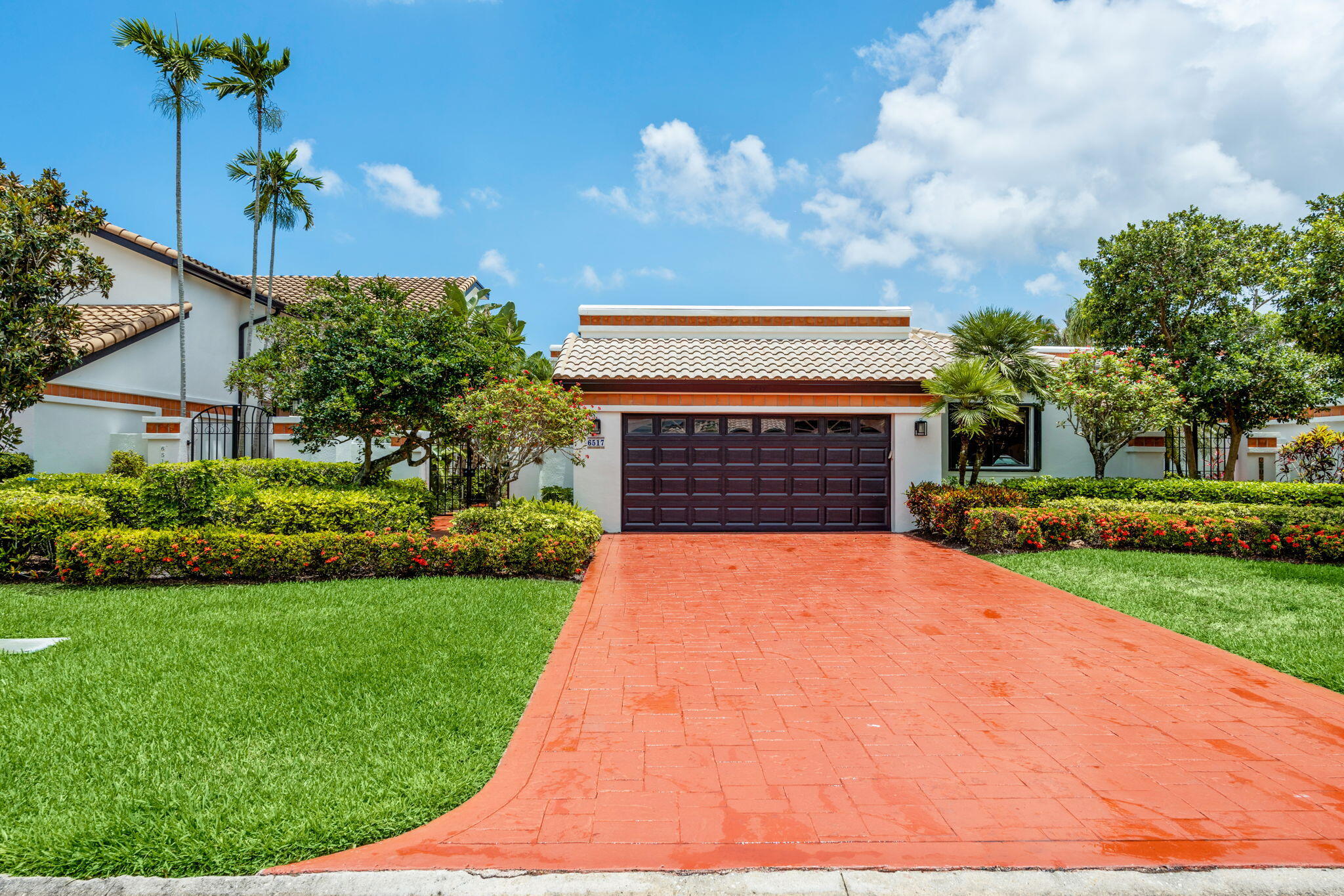 Bright, beautiful, and inviting home in the gated Villa Flora section of Boca Pointe featuring a dramatic great room with soaring ceilings, custom built-ins, architectural niches, and abundant natural light throughout. The exceptional oversized screened and covered lanai serves as a true extension of the living space, surrounded by lush tropical landscaping and offering multiple areas for entertaining, dining, or relaxing year-round. Kitchen features newer stainless steel appliances, an eat-in area, and opens to the main living and dining spaces. Desirable split-bedroom floor plan offers privacy and functionality, along with a spacious primary suite and two-car garage. Optional membership available at The Club at Boca Pointe with golf, tennis, fitness, dining, and social amenities.