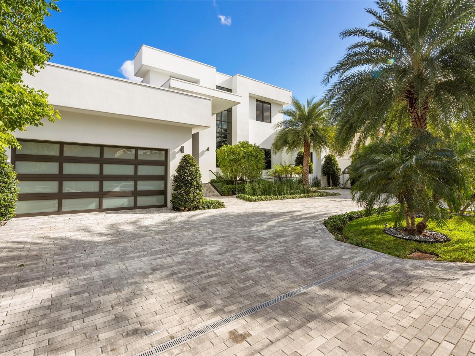Masterpiece along Fort Lauderdale's iconic Intracoastal in prestigious Coral Ridge offers 5 beds, 4.5 baths, and 4,524 SQFT of luxury on a 12,000 SQFT lot. Unobstructed views of Birch Park and shimmering water pair with floor-to-ceiling windows for breathtaking natural light and moonlit ambiance. The catering-style kitchen features Miele & Bosch appliances, ideal for entertaining. Live-edge built-ins add natural elegance, while luxurious zero-entry porcelain showers, including an outdoor shower, provide spa-like comfort. Thoughtfully wheelchair accessible with 4 Trane AC units for year-round climate control.