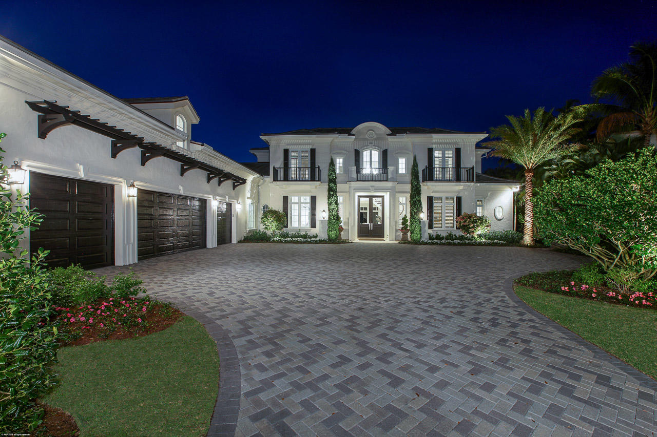 THIS ELEGANT HOUSE IS A COMPLETE SHOW STOPPER in prestigious Admirals Cove. This property has everything from the golf course in the front yard to the water in the rear. Inside this beautiful home you will find a spacious foyer, a split bedroom layout, vaulted ceilings, custom built-ins, walk-in closets, hurricane impact glass, recessed lighting, beautiful chandeliers, even an elevator. You will love the gourmet chef's kitchen offering an open design with a large cook island, stunning counter-tops, top of the line appliances, beautiful cabinetry, and a large eat-in area with views of the pool. The rear exterior of this property is even more impressive offering a covered loggia w/ full summer kitchen, TV, fireplace, and electric screen. A must see and will not last.