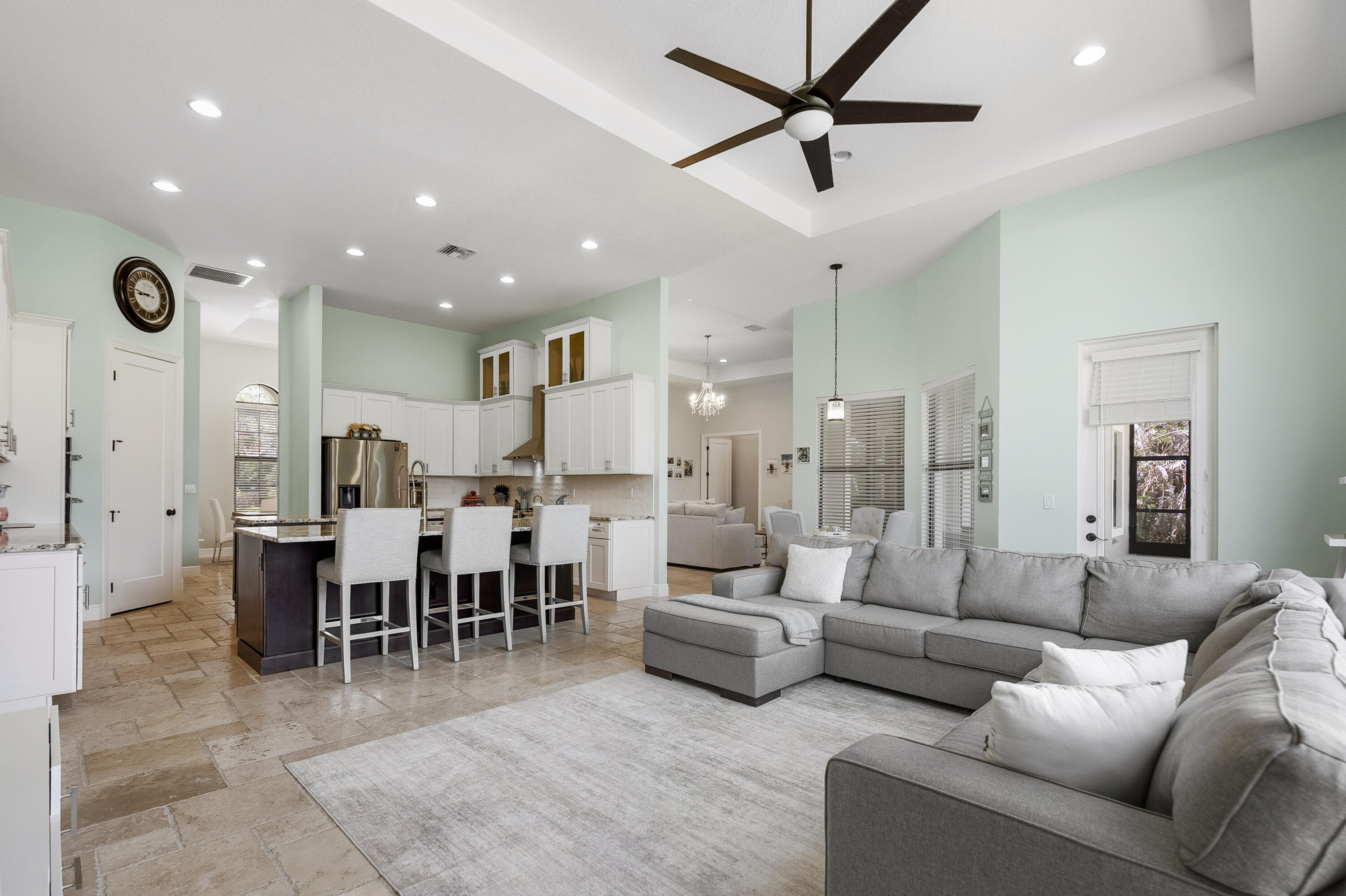 Custom-built in 2018, this Palm City estate offers refined indoor-outdoor living, thoughtful upgrades, and exceptional privacy in one of the area's most desirable communities. Features include impact glass throughout, chef-inspired kitchen with dual islands and premium appliances, heated saltwater pool and spa, screened patio, fire pit gathering area, expanded paver driveway, Tesla EV charger, and upgraded well and irrigation systems. The cleared homesite offers generous usable space for everyday living, entertaining, and recreation, while preserved natural surroundings create a serene wooded backdrop, remarkable privacy, and peaceful views rarely found in South Florida. Luxury, function, and tranquility come together in this exceptional property.