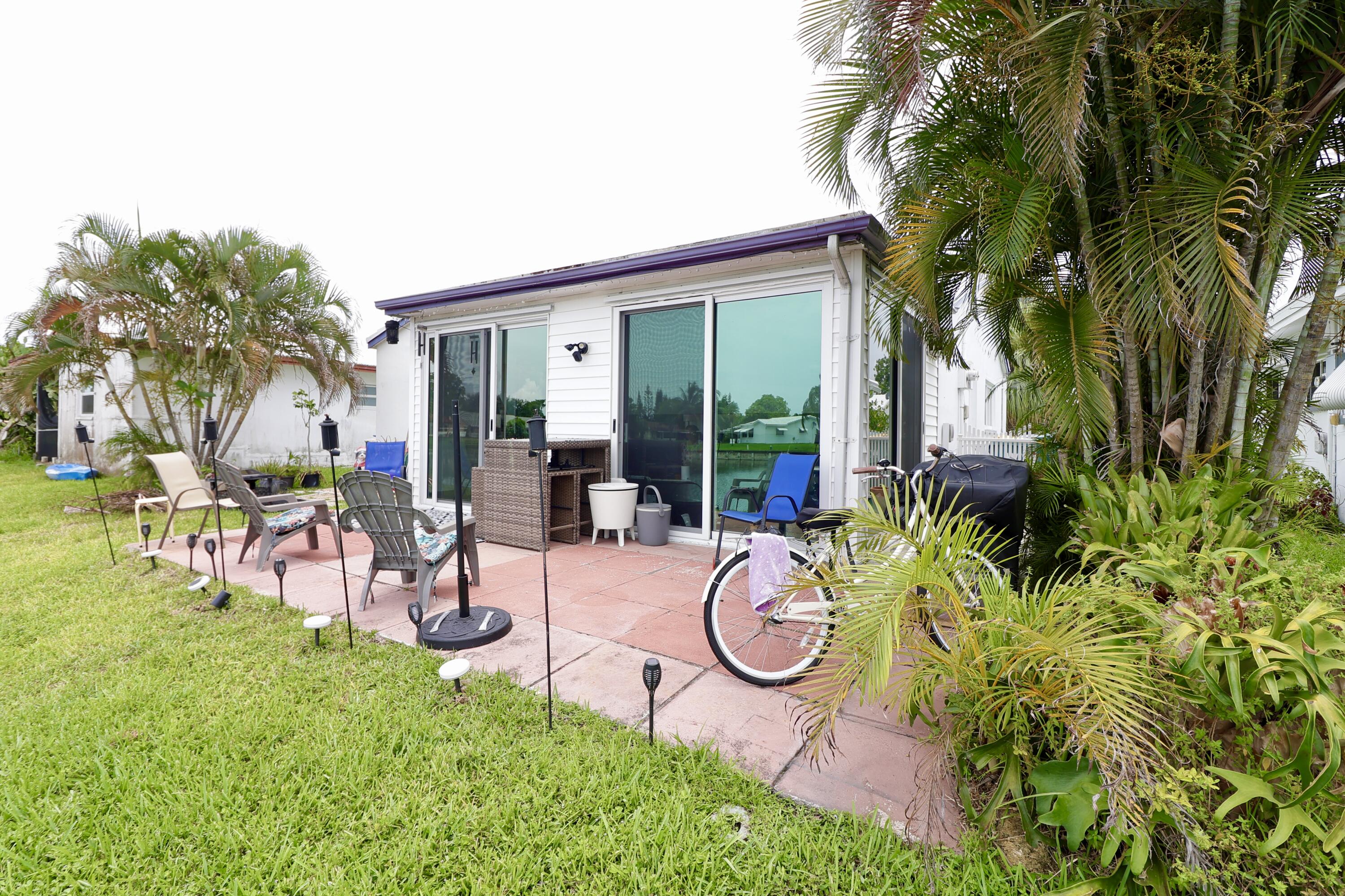 MUST SEE!   Enjoy stunning water views the moment you walk through the front door.  Beautifully updated, this home offers a paved driveway with parking for two vehicles, a modern kitchen featuring granite countertops and stainless-steel appliances, and durable new vinyl flooring throughout. Abundant natural lighting fills the living spaces, while the spacious family room provides the perfect setting for relaxing. For added peace of mind, the home is equipped with complete hurricane protection, including impact-resistant windows and doors. The back porch offers a quiet evening sunset with comfort and peace overlooking the water view. Low monthly HOA fees include lawn care, making for easy, low-maintenance living.